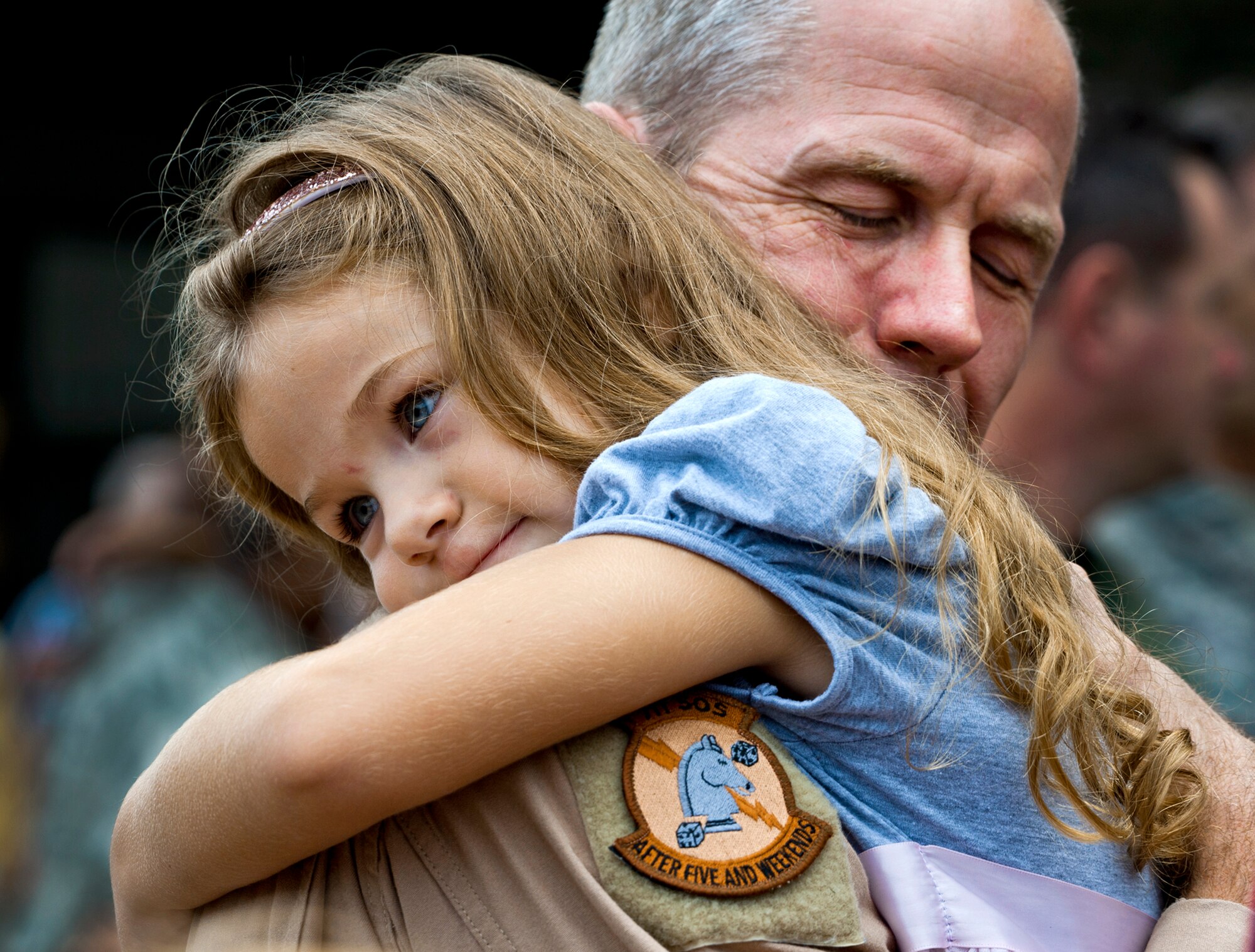 Lt. Col. Thomas Frazier of the 711th Special Operations Squadron receives an overdue hug from his daughter after returning from a deployment to Southwest Asia on Aug. 7, 2011. More than 25 Air Force Reserve Airmen were welcomed back home at a homecoming party at Duke Field, Fla. (U.S. Air Force photo/Tech. Sgt. Samuel King Jr.)