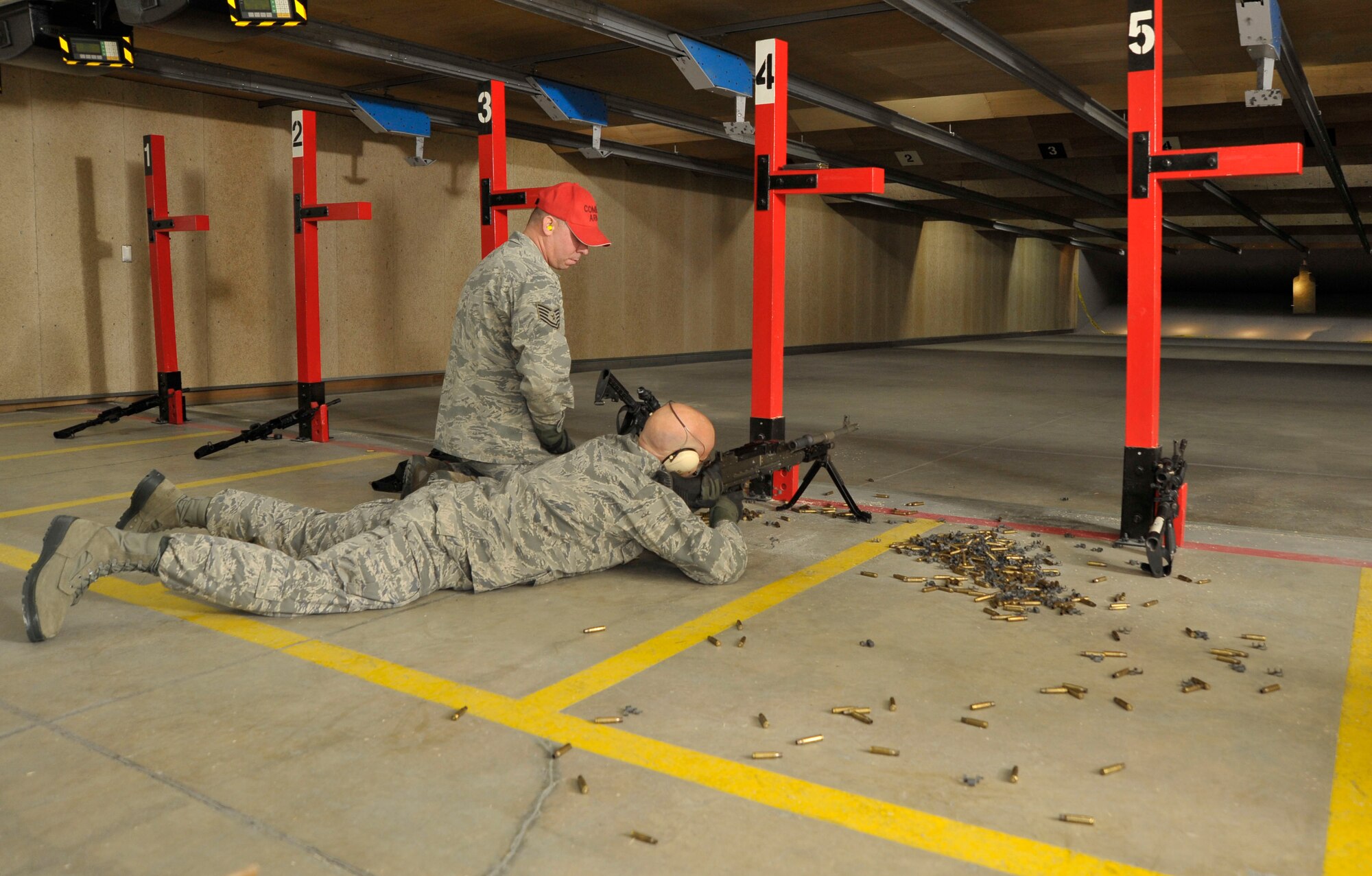 MISAWA AIR BASE, Japan -- Tech. Sgt. Jeremy Potts, left, 35th Security Forces Squadron, non-commissioned officer in charge of combat arms, instructs Col. Dwayne Robison, 35th Civil Engineers Squadron commander, on how to operate the M-240 machine gun here Jan. 4. After almost 10 months of closure, the 35th Security Forces Squadron's Combat Arms Training and Maintenance Range has reopened. (U.S. Air Force photo/Staff Sgt. Nathan Lipscomb)