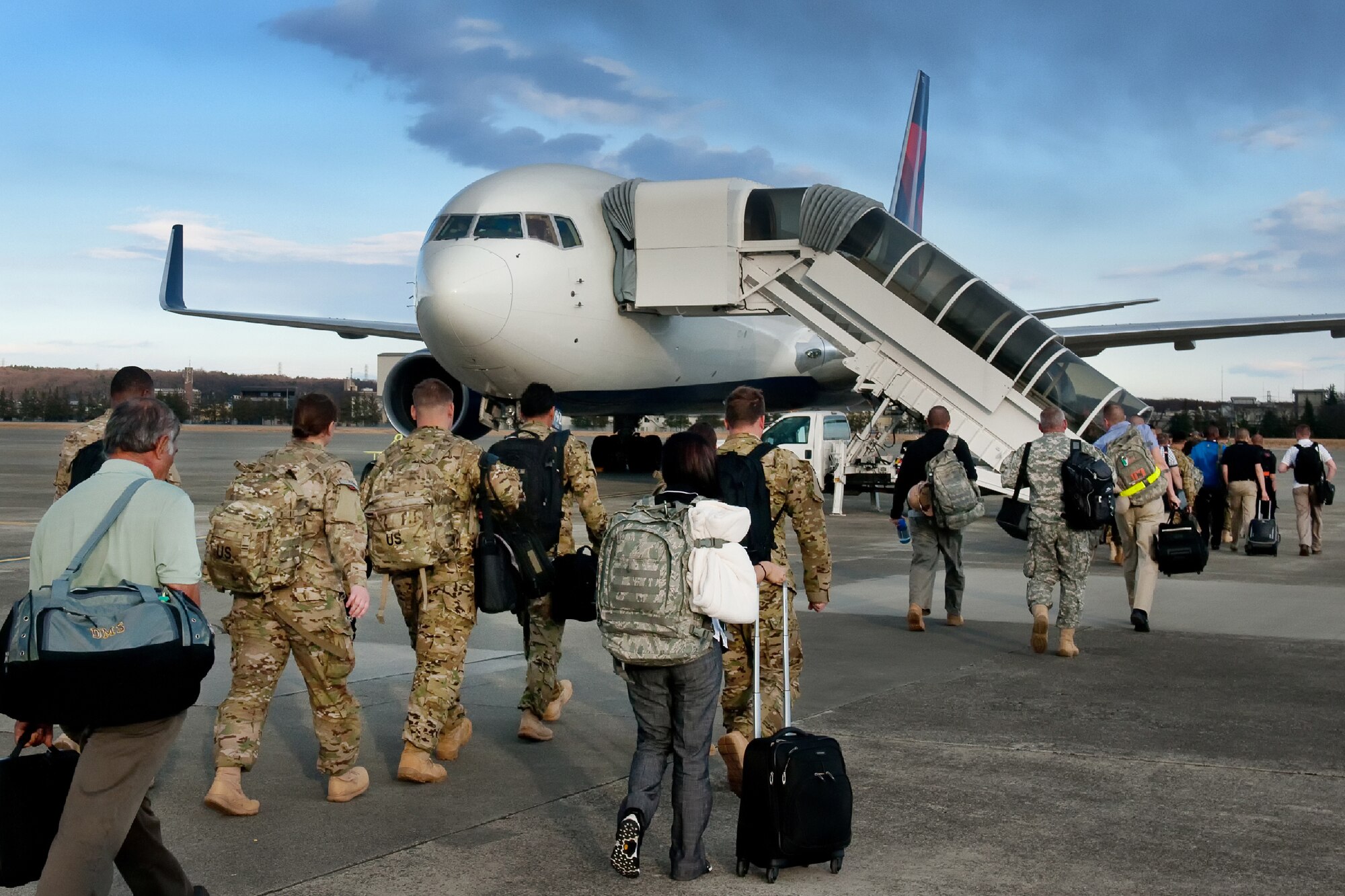 YOKOTA AIR BASE, Japan -- Soldiers from the 83rd Infantry Division, board a Boeing 737, at the Yokota passenger terminal, Jan. 4, 2011 to support a Joint Air Expeditionary Force mission, sponsored by the U.S. Transportation Command at Navy Support Facility Diego Garcia. (U.S. Air Force photo/Osakabe Yasuo)