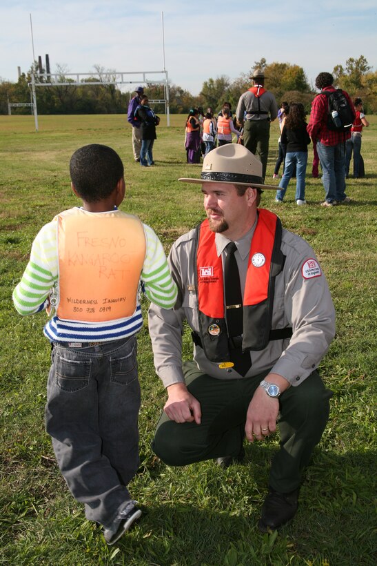 USACE Natural Resources Manager Bart Dearborn helps a DC Middle School student with his lifejacket before canoeing in the Potomac River.