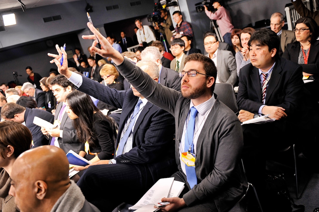 Members of the press raise their hands to ask questions after President Barack Obama, Defense Secretary Leon E. Panetta and Army Gen. Martin E. Dempsey, chairman of the Joint Chiefs of Staff, discussed the new defense strategy at the Pentagon, Jan. 5, 2012.