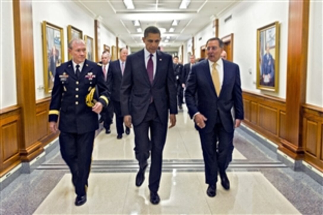 President Barack Obama walks with Defense Secretary Leon E. Panetta and Army Gen. Martin E. Dempsey, chairman of the Joint Chiefs of Staff, to a press briefing at the Pentagon, Jan. 5, 2012. Obama and Panetta delivered remarks on a defense strategy for the Defense Department going forward. They were joined by Deputy Defense Secretary Ashton B. Carter and the members of the Joint Chiefs and service secretaries.