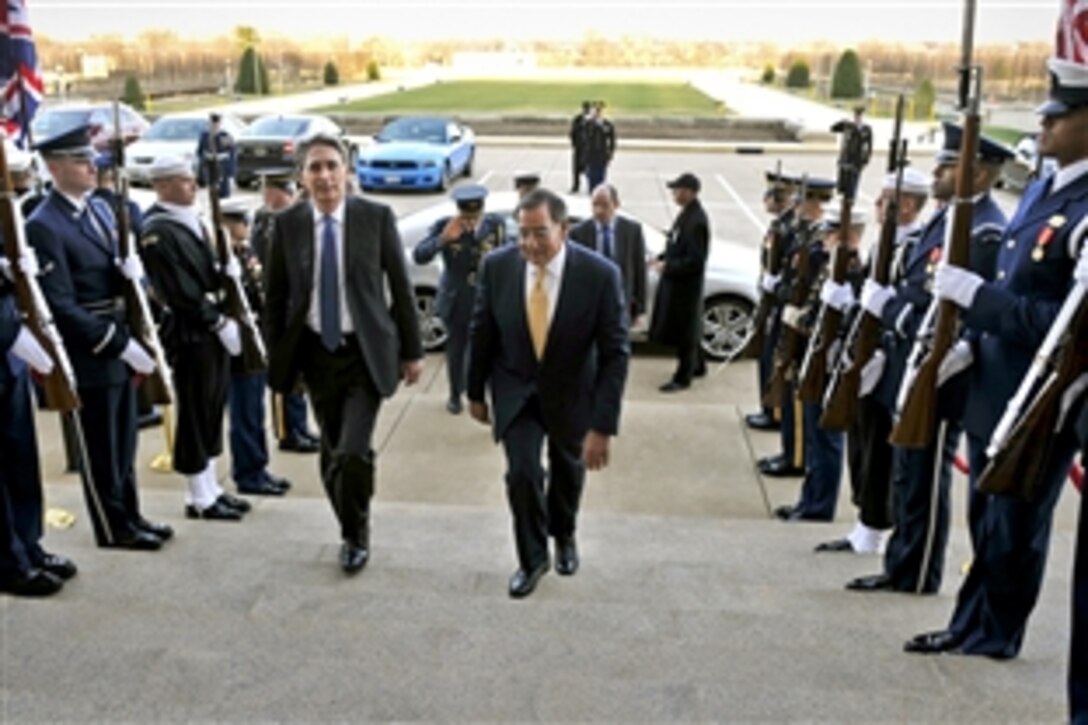 U.S. Defense Secretary Leon E. Panetta escorts the United Kingdom's Secretary of State for Defense Philip Hammond through an honor cordon into the Pentagon, Jan. 5, 2012. They met to sign a statement of intent concerning enhanced cooperation on carrier operations and maritime power projection at the Pentagon, Jan. 5, 2012.