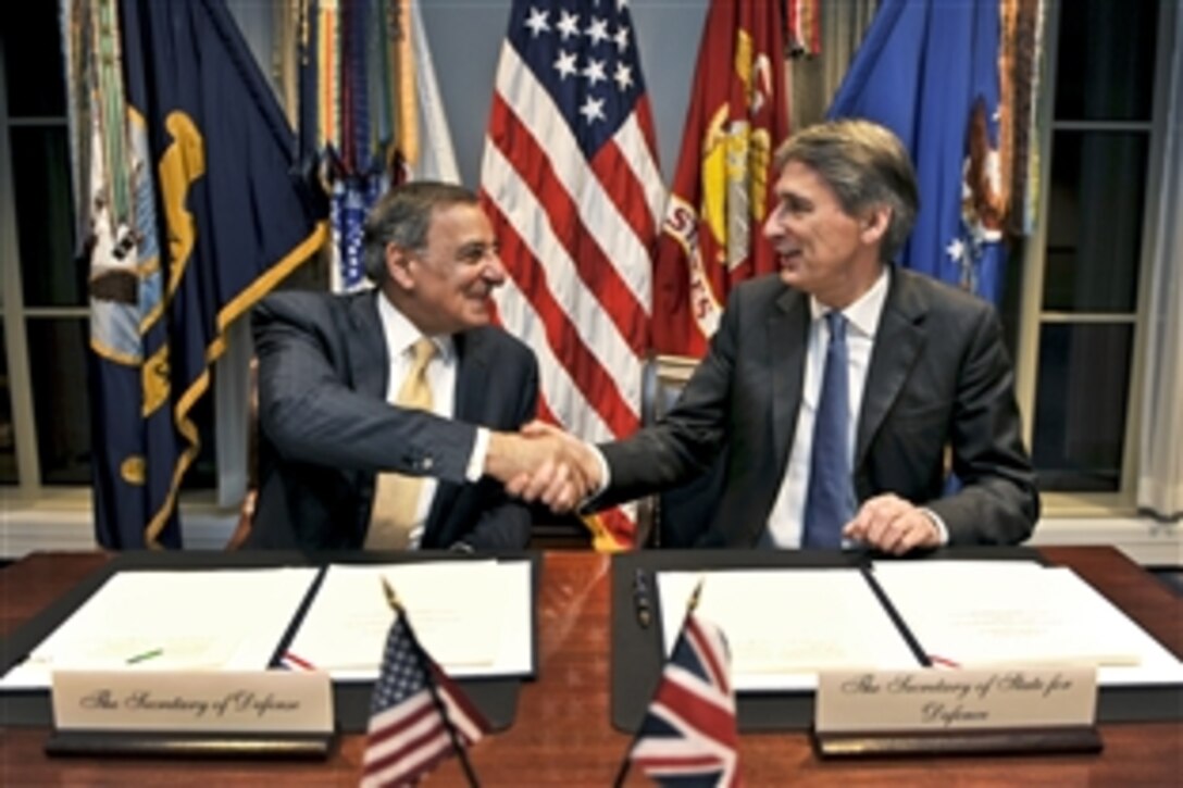 U.S. Defense Secretary Leon E. Panetta shakes hands with the United Kingdom's Secretary of State for Defense Philip Hammond after signing a statement of intent concerning enhanced cooperation on carrier operations and maritime power projection at the Pentagon, Jan. 5, 2012. 