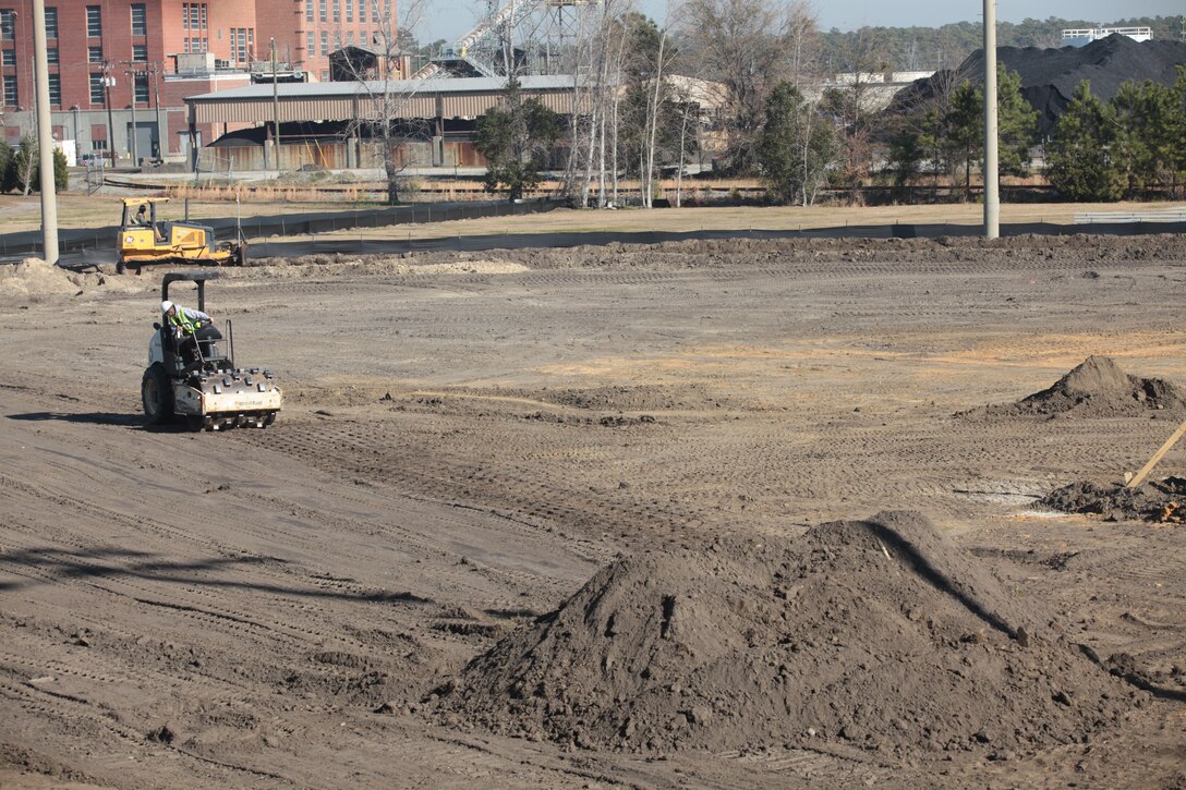 Construction workers clear the Harry Agganis Field aboard Marine Corps Base Camp Lejeune in preparation for artificial turf. The $4.5-million construction project to renovate the Harry Agganis Field, intramural soccer and football fields, and the Liversedge Field is scheduled to be completed by late May, weather permitting.