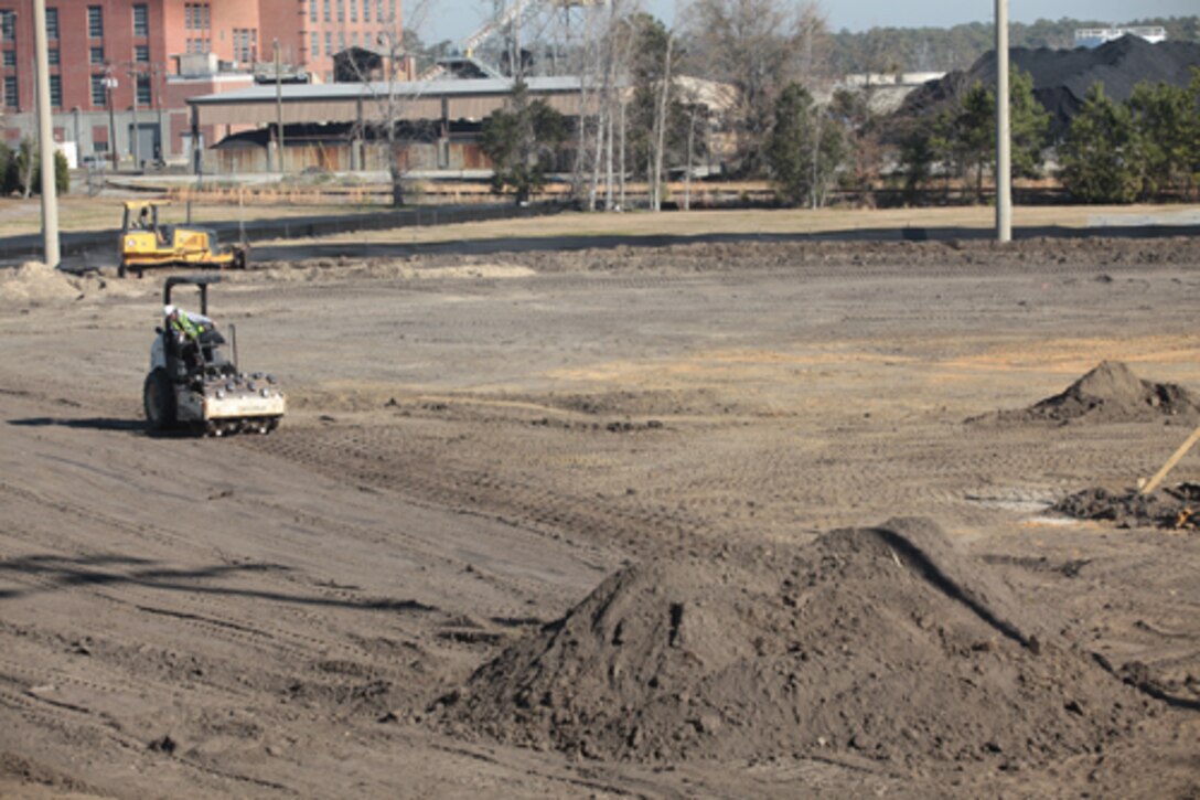 Construction workers clear the Harry Agganis Field aboard Marine Corps Base Camp Lejeune in preparation for artificial turf. The $4.5-million construction project to renovate the Harry Agganis softball field, intramural soccer and football fields, and the Liversedge Field is scheduled to be completed by late May, weather permitting.