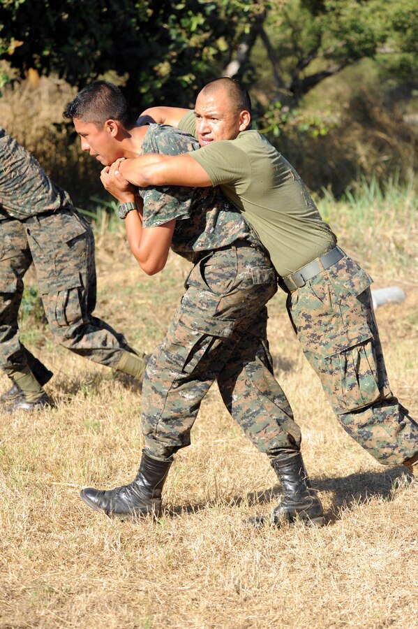 Hospitalman 3rd Class Jorge Juarez, assigned to the Marine detachment aboard High Speed Vessel (HSV 2) Swift, is buddy dragged across a field by a Guatemalan paratrooper during a physical training session.  The exercise is part of a 10-day subject matter expert exchange between Guatemalan and U.S. service members during HSV-Southern Partnership Station 2012 (HSV-SPS 12).  HSV-SPS is an annual deployment to build partnerships in the Caribbean and Latin America.