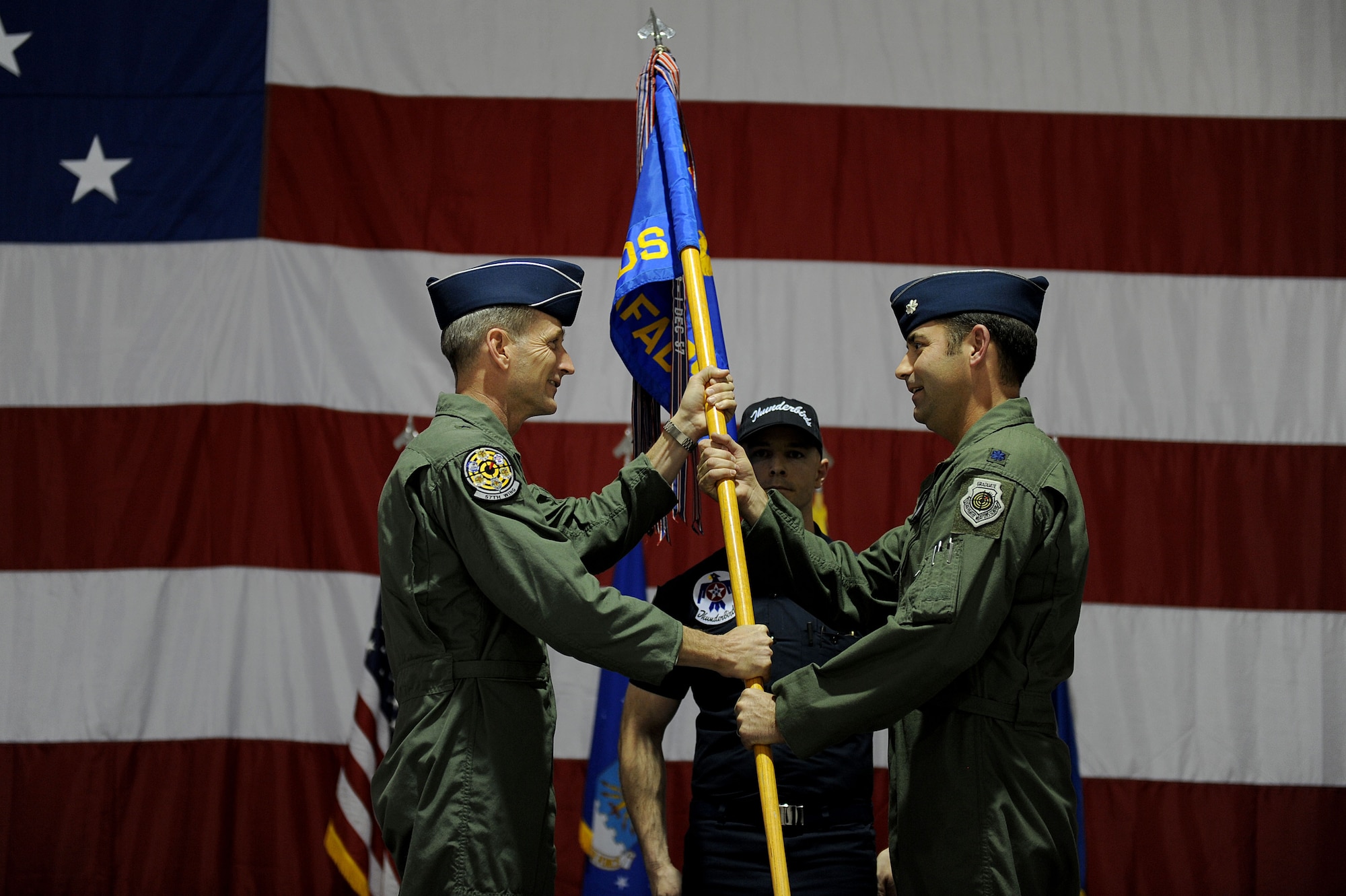 Brig. Gen. Terrence J. O'Shaughnessy, 57th Wing Commander, passes the U.S. Air Force Air Demonstration Squadron "Thunderbirds" guidon to Lt. Col. Gregory Moseley during the change of command ceremony, Jan. 6, 2012. Lt. Col. Moseley assumes command from Lt. Col. Case Cunningham.
(U.S. Air Force photo/Staff Sgt. Larry E. Reid Jr., Released)