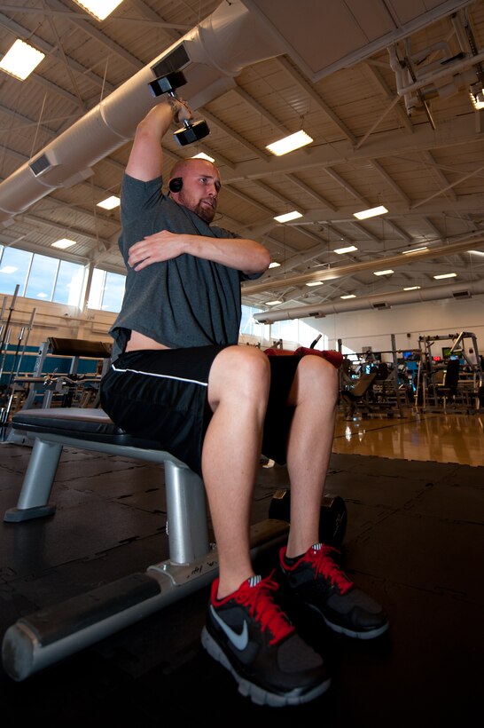 Clay Mueller, spouse of an Airman, lifts dumbbells in the Bellamy Fitness Center on Ellsworth Air Force Base, S.D., Jan. 5, 2012. The fitness center recently received the Air Combat Command Fitness and Sports Program of the Year award, for providing great fitness programs and services for the EAFB community. (U.S. Air Force photo by Airman 1st Class Kate Thornton/Released)
