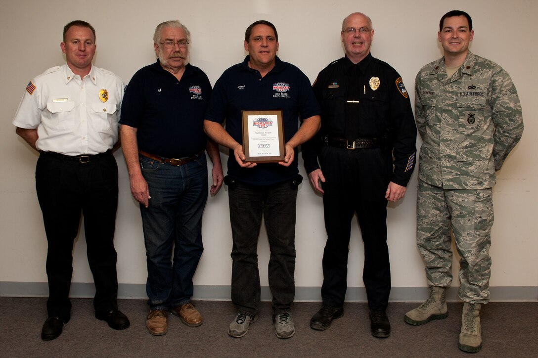 (From left to right) Christopher Gleason, Box Elder Fire Department chief; Al Todd, Box Elder Public Works director; Al Dial, mayor of Box Elder; Timothy Ryan, Box Elder Police Department chief and Maj. Steven Ohlmeyer, 28th Security Forces Squadron Commander, accept a National Night Out award at the City Hall in Box Elder, S.D., Jan. 5, 2012. Box Elder was the only city in South Dakota to receive the award, which is the result of the five organizations teaming up with the community and supporting the NNO mission of crime and drug prevention. (U.S. Air Force photo by Airman 1st Class Kate Thornton/Released) 