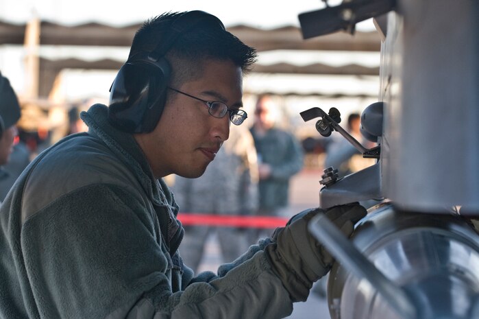U.S Air Force Staff Sgt. Jason Spears, 57th Aircraft Maintenance Squadron weapons load crew chief, loads a Mark-82 bomb on an F-16 Fighting Falcon during the quarterly weapons load competition Jan. 6, 2012, at Nellis Air Force Base, Nev. Weapons load competitions are conducted quarterly to keep Airmen sharp and recognize superior performers. Weapons load teams are evaluated for use of the checklist, safety, and overall speed.  (U.S. Air Force photo by Airman 1st Class Matthew Lancaster/Released)