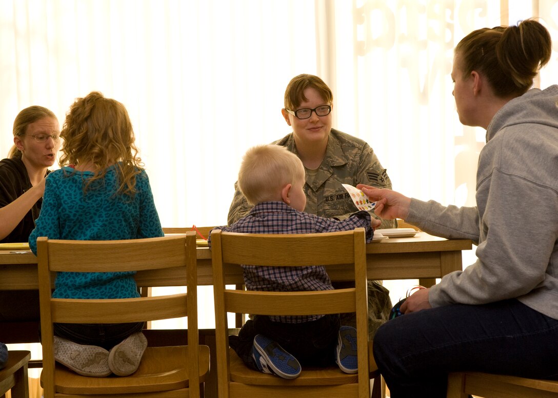 Senior Airman Mindi Bollig, 28th Force Support Squadron services journeyman, interacts with parents and children during Little Warriors Story Time at the Holbrook Library on Ellsworth Air Force Base, S.D., Jan. 5, 2012.  Little Warriors Story Time is held every Thursday at 11 a.m. (U.S. Air Force photo by Airman 1st Class Anania Tekurio/released)