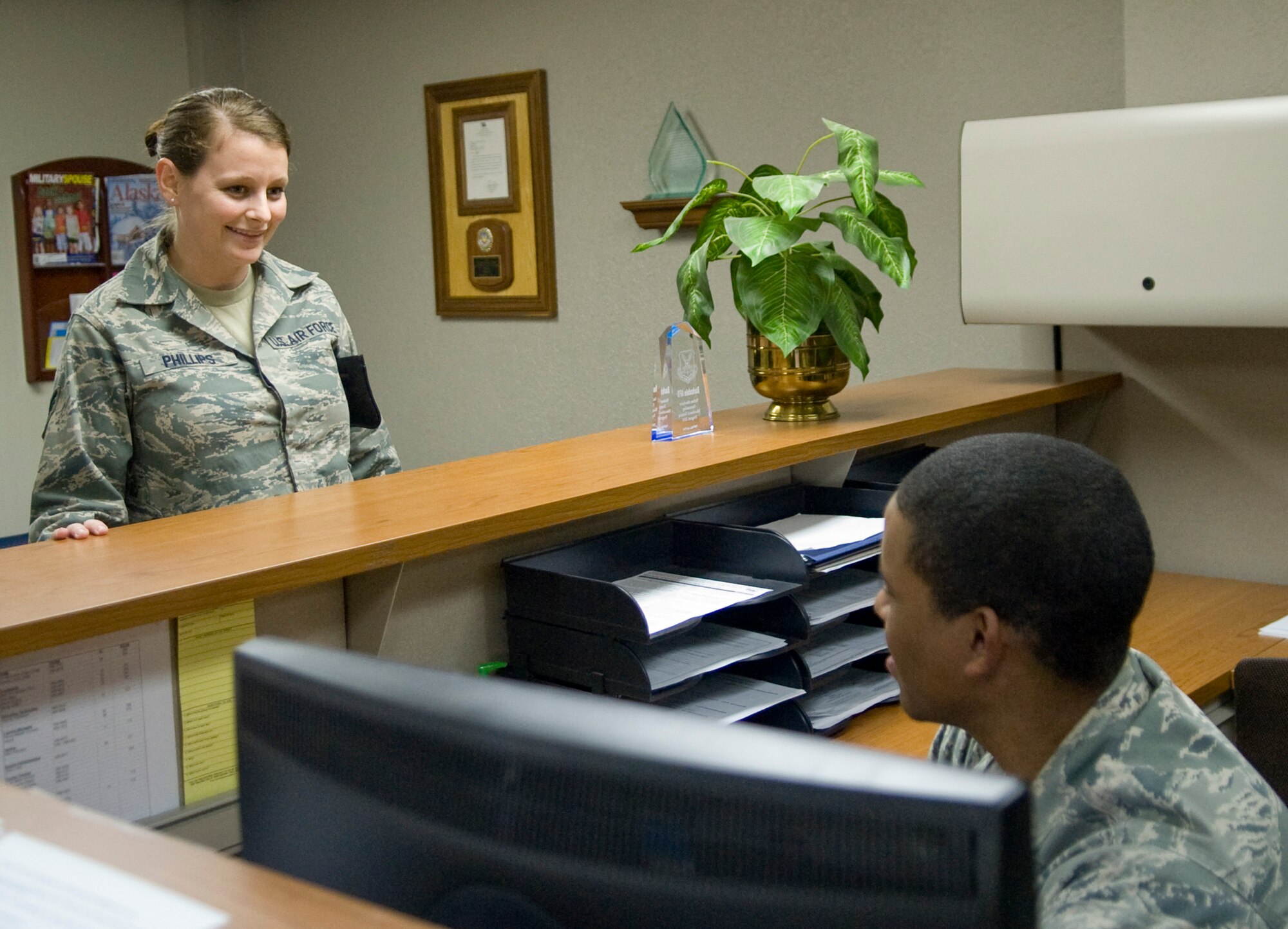 Senior Airman Marcella Phillips, 2nd Aircraft Maintenance Squadron, receives information on Tuition Assistance briefings from Senior Airman Chevalier Harmon, 2nd Force Support Squadron, in the Base Training and Education Services center on Barksdale Air Force Base, La., Jan. 6. Airmen are at the front desk until Feb. 1 when customer service front desk operations will cease. (U.S. Air Force photo/ Senior Airman Kristin High)(RELEASED)