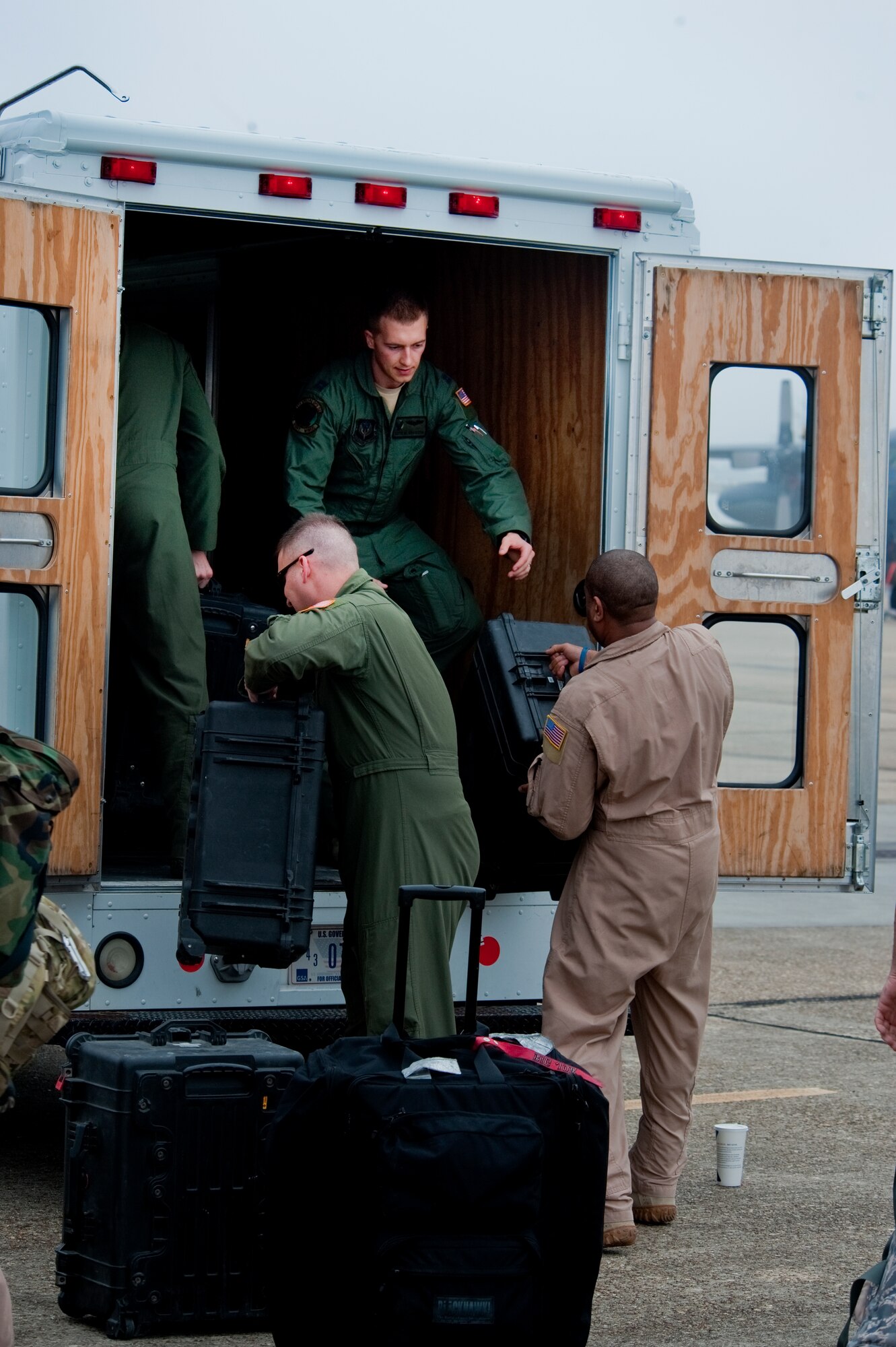 Airman from the 9th Special Operations Squadron pack ?bread trucks? with returning service members? gear after returning from a deployment to Iraq, Jan. 6, 2012. Operation Iraqi Freedom was followed by Operation New Dawn Sept. 1, 2010, as the mission changed. (U.S. Air Force photo/Airman 1st Class Christopher Williams)(Released)