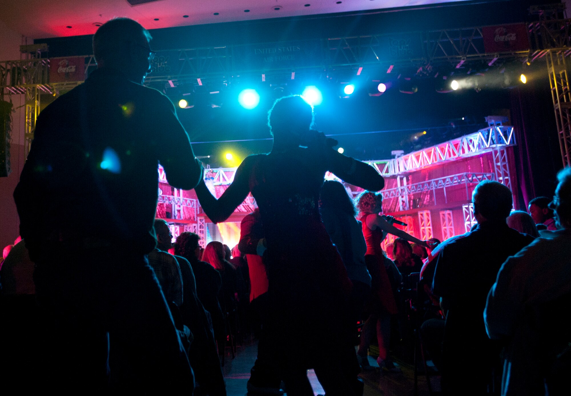 Vocalist Senior Airman Emerald Payne sings and dances with an audience member during Tops in Blue’s performance at Century II Performing Arts and Convention Center Jan. 4, 2012, Wichita, Kan. The 2011 tour, entitled “Rhythm Nation,” took the audience on a musical journey with tunes from the early 1900s to today. (U.S. Air Force photo/ Airman 1st Class Laura L. Valentine)