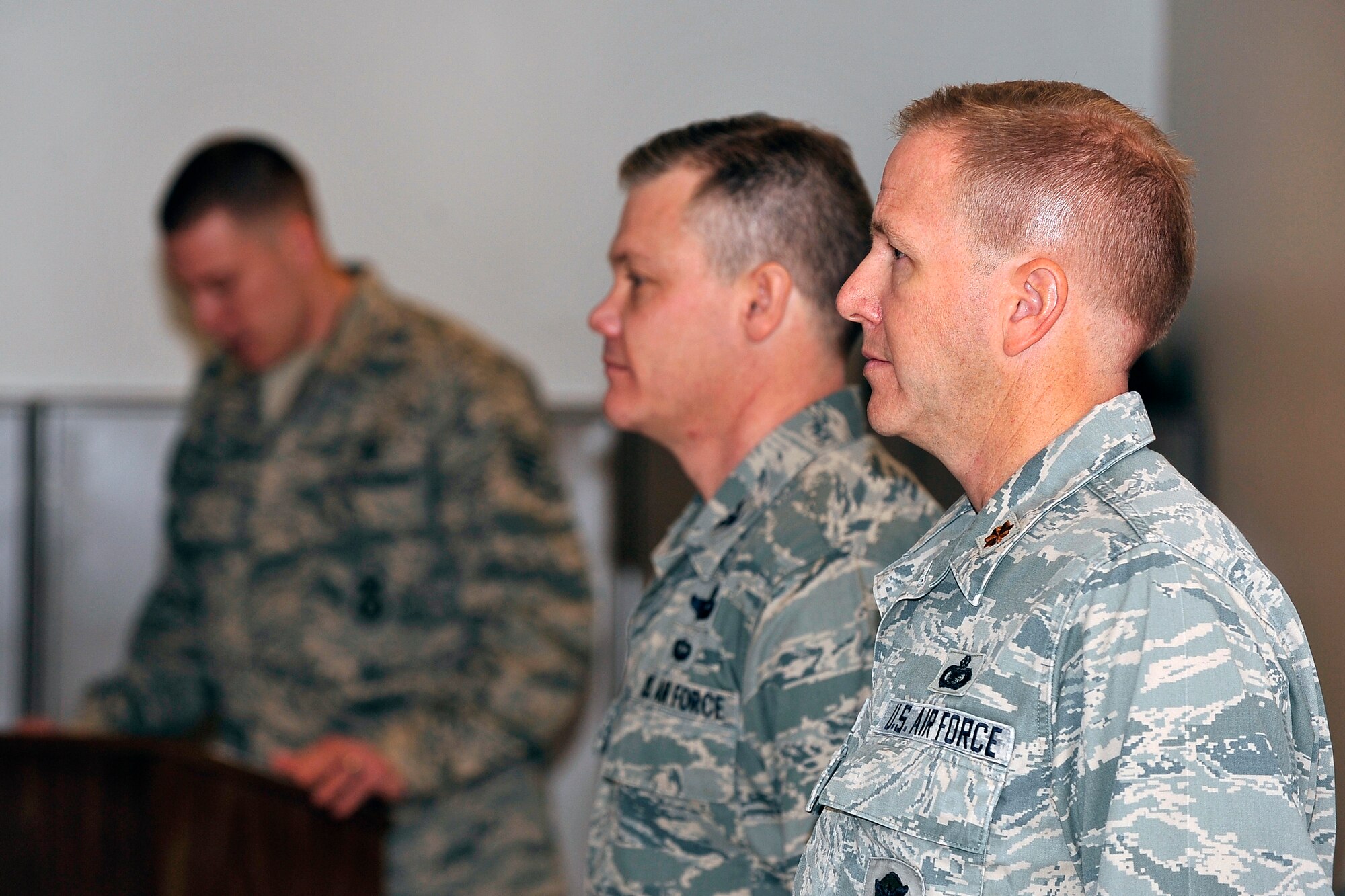 From right: Maj. Brent McGuire and Col. Tim Gibson stand attention during the reading of the citation for McGuire's Bronze Star Medal during a presentation ceremony at the Air Force Academy Jan. 6, 2012. McGuire, a reservist who works in a civilian capacity as a security forces trainer for the 10th Security Forces Squadron, received the medal for his actions while deployed to Kandahar Air Field, Afghanistan, as the 451st Expeditionary Security Forces Squadron commander. Gibson is the 10th Air Base Wing commander. (U.S. Air Force photo/Elizabeth Andrews)