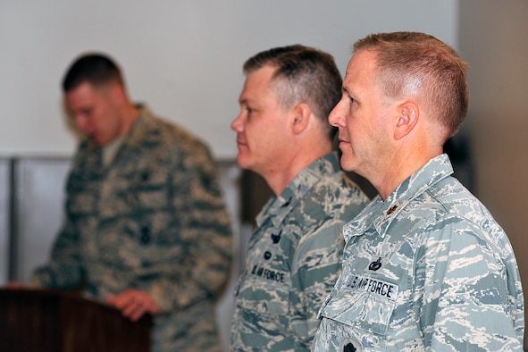 From right: Maj. Brent McGuire and Col. Tim Gibson stand attention during the reading of the citation for McGuire's Bronze Star Medal during a presentation ceremony at the Air Force Academy Jan. 6, 2012. McGuire, a reservist who works in a civilian capacity as a security forces trainer for the 10th Security Forces Squadron, received the medal for his actions while deployed to Kandahar Air Field, Afghanistan, as the 451st Expeditionary Security Forces Squadron commander. Gibson is the 10th Air Base Wing commander. (U.S. Air Force photo/Elizabeth Andrews)