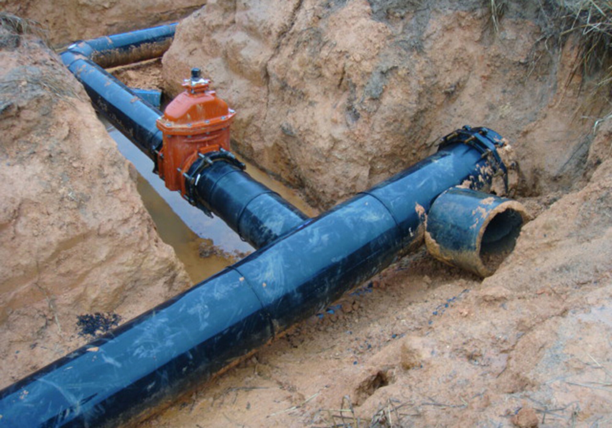 Existing base waterlines are replaced with pipelines made with a durable and thick plastic called High Density Polyethylene, or HDPE. One of the advantages of HDPE piping is the joints may be fusion welded, similar to the welding of steel. This results in a much stronger and durable joint than the solvent welds used on PVC piping, which the civil engineers have had difficulties with in the past. (Courtesy photo)