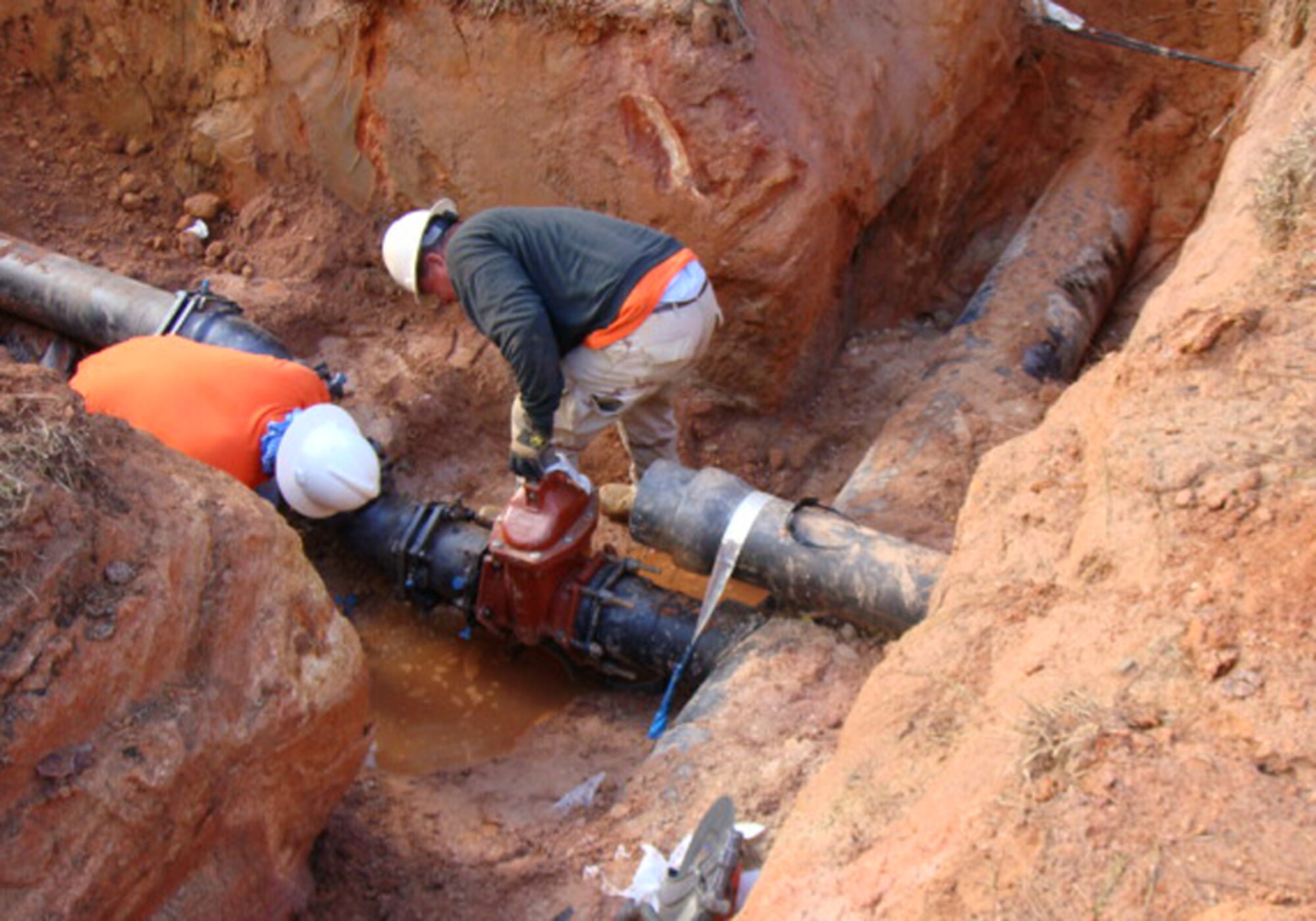 Under the direction of Dobbins Civil Engineering, contractors from Cape/CDM install waterlines as part of a five month base project. The project, which began in Aug. 19, includes the installation of new water lines, looping the waterline system on the north side of the base, installing an inter-connecting line between the north and south sides of the base and repairing existing waterlines along Refueling Road, serving the Fire Department, Communications Squadron, Security Forces Squadron and Hangers B746 and 747. (Courtesy photo)