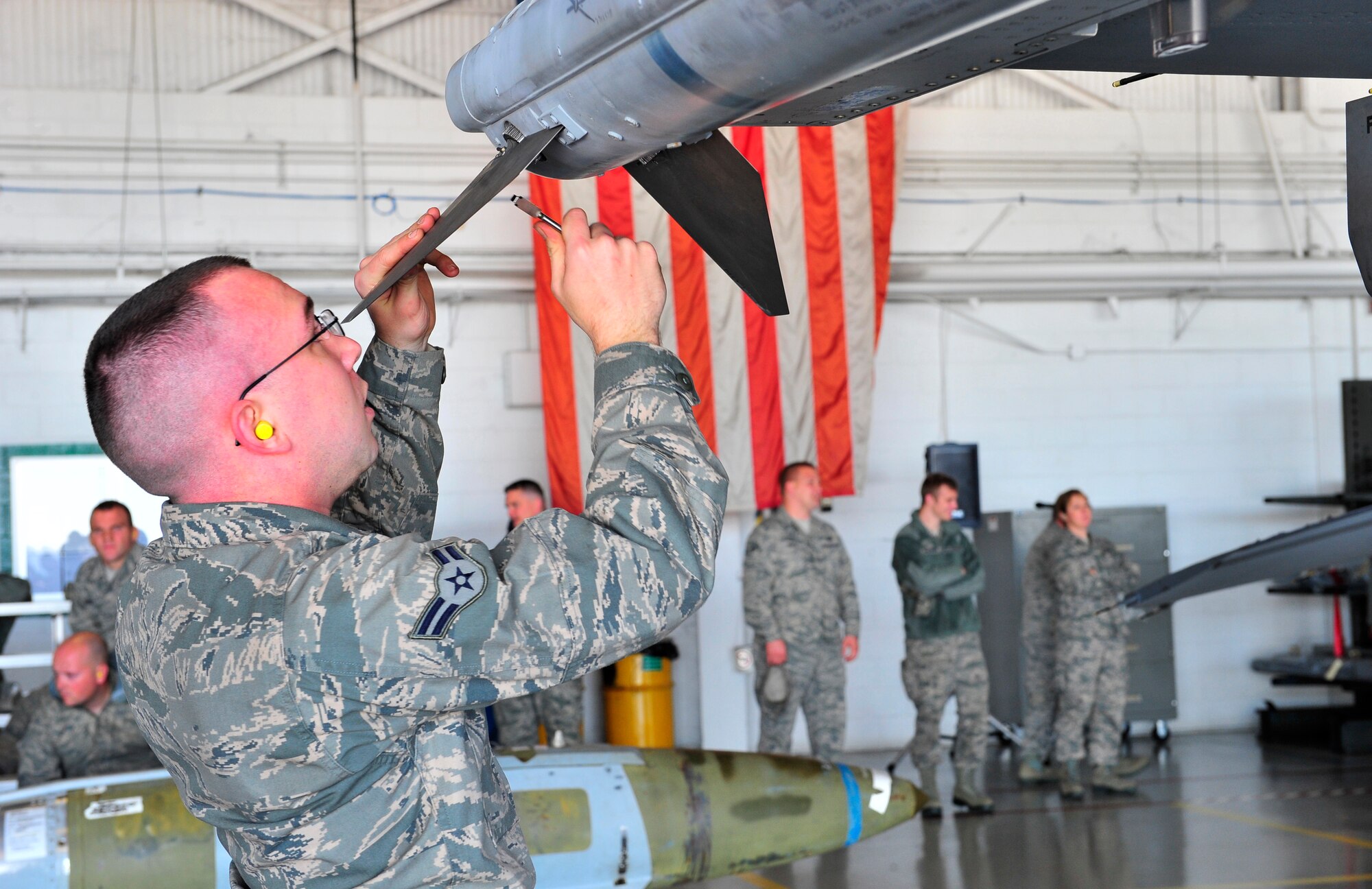 U.S. Air Force Airman 1st Class Douglas Hillman, 79th Aircraft Maintenance Unit weapons load member, attaches a fin onto an air intercept missile (AIM-120) Jan. 6, 2012, Shaw Air Force Base, S.C. Wing weapons standardization sponsored the first Weapons Load Crew of the Quarter competition for 2012. The 55th, 77th and 79th Aircraft Maintenance Units weapons load crews competed against each other in a race against time. (U.S. Air Force photo by Senior Airman Amber E. N. Jacobs/Released) 