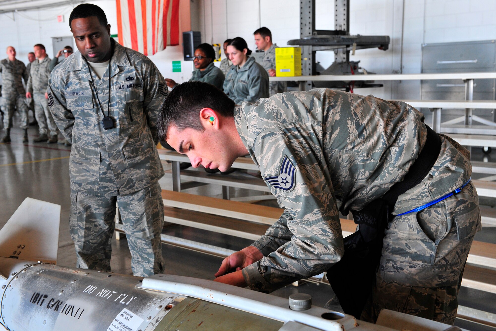 U.S. Air Force Staff Sgt. Richard Randall, 55th Aircraft Maintenance Unit weapons load member, prepares a joint direct attack munition to be loaded on to an F-16 Fighting Falcon while Tech. Sgt. Antran Pack, Weapons Standardization, judges Randall’s progress and procedures Jan. 6, 2012, Shaw Air Force Base, S.C. Wing weapons standardization sponsors the first Weapons Load Crew of the Quarter Competition for 2012. The 55th, 77th and 79th Aircraft Maintenance Units Weapons load crews competed against each other in a race against time. (U.S. Air Force photo by Senior Airman Amber E. N. Jacobs/Released) 