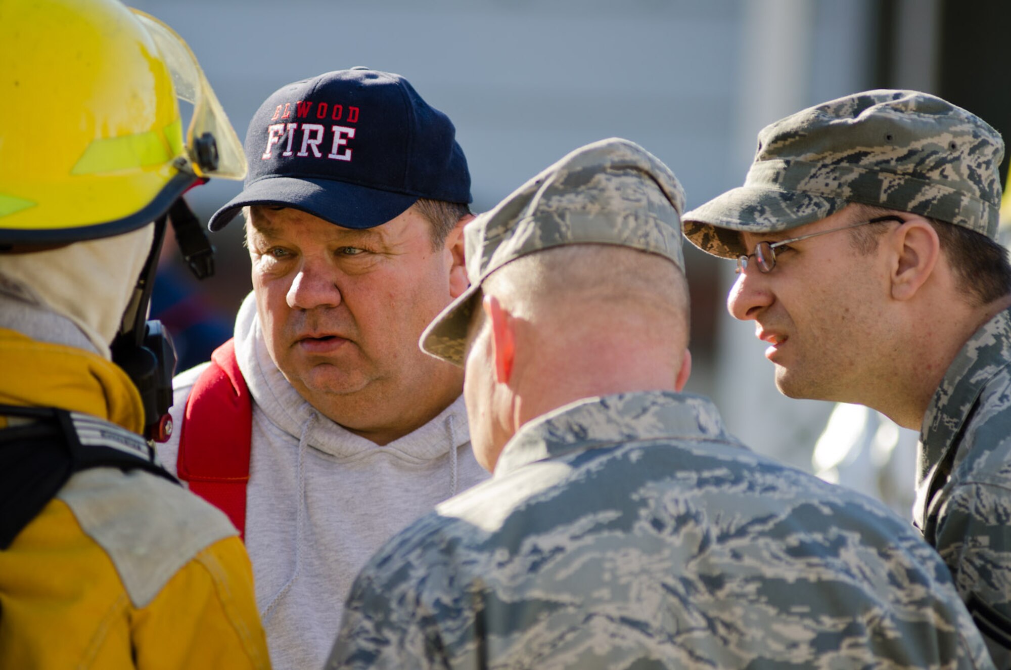 Alvin Wood, Elwood fire chief, talks with a local firefighter in Elwood, Kan., Jan. 5, 2012. Airmen from Rosecrans Air Guard Base, St. Joseph, Mo., assisted local fire departments with a residential fire. (Missouri Air National Guard photo by Staff Sgt. Michael Crane)