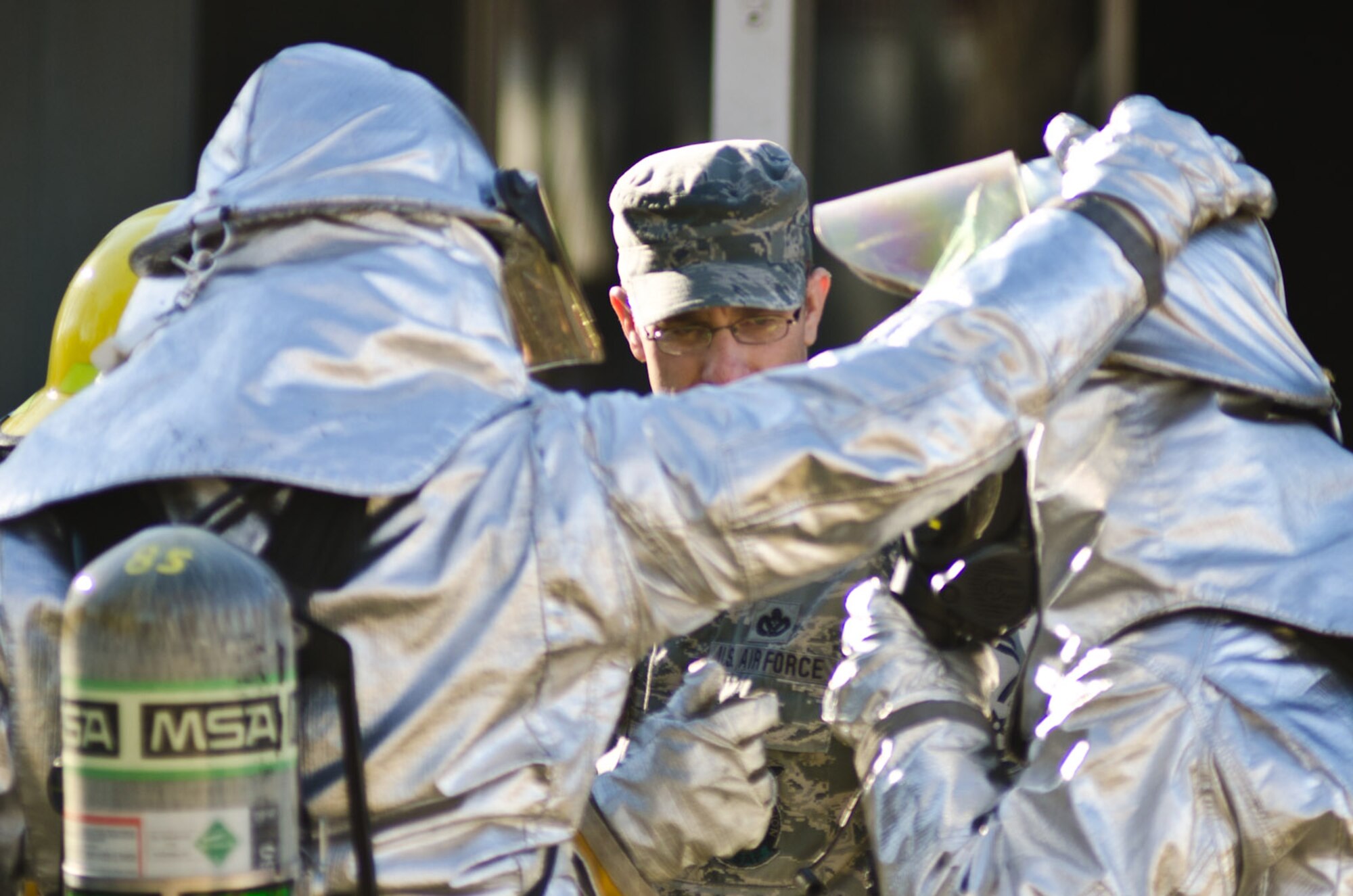 Senior Master Sgt. Brian Jansen, 139th Airlift Wing fire chief, assists Airmen with their firefighting gear in Elwood, Kan., Jan. 5, 2012. Airmen from Rosecrans Air Guard Base, St. Joseph, Mo., assisted local fire departments with a residential fire. (Missouri Air National Guard photo by Staff Sgt. Michael Crane)