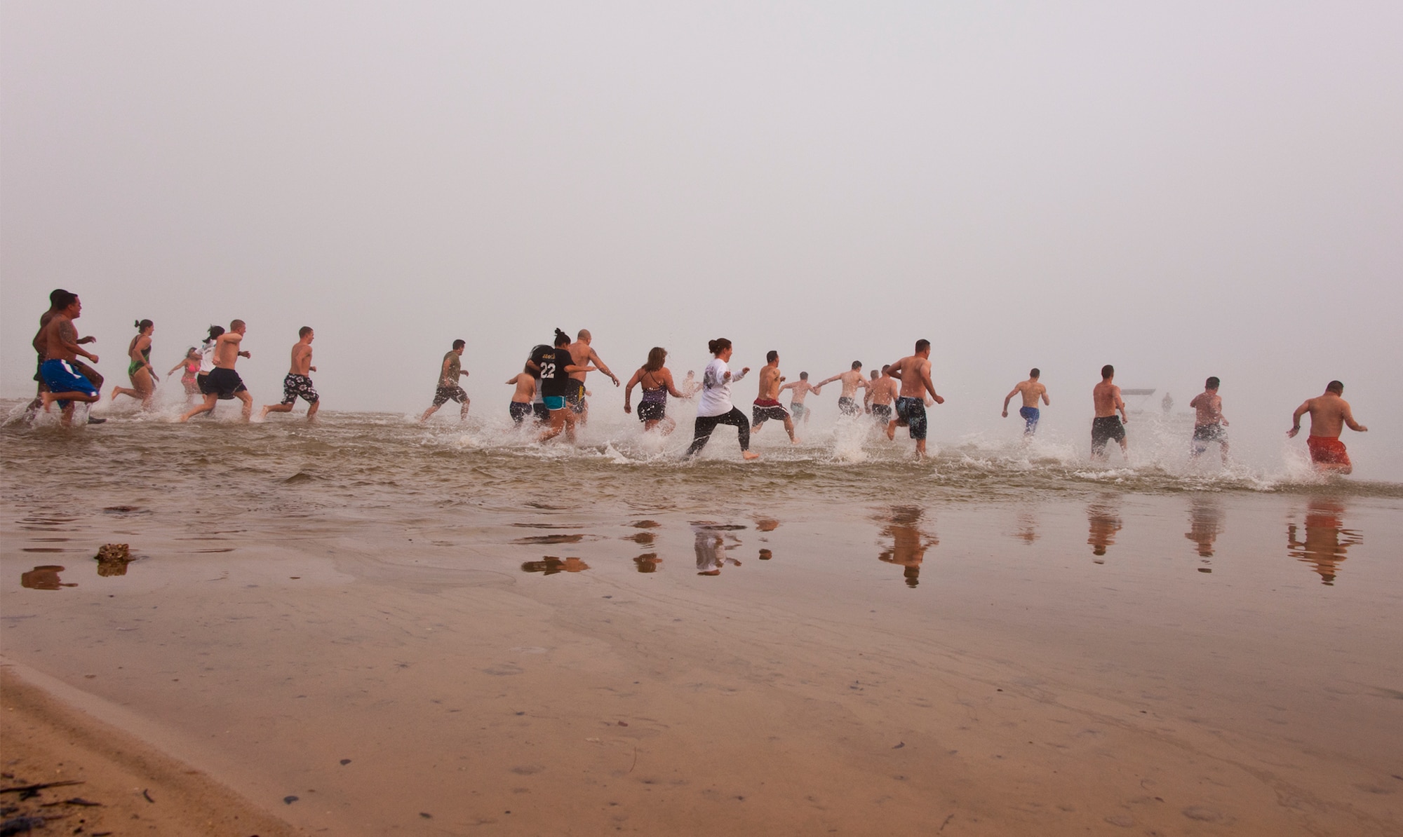 Almost 30 people rush into the chilly waters of Choctawhatchee Bay during Eglin’s second annual Polar Bear swim, held at Post’l Point, Jan. 6.  (U.S. Air Force photo/Samuel King Jr.)