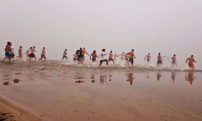 Almost 30 people rush into the chilly waters of Choctawhatchee Bay during Eglin’s second annual Polar Bear swim, held at Post’l Point, Jan. 6.  (U.S. Air Force photo/Samuel King Jr.)