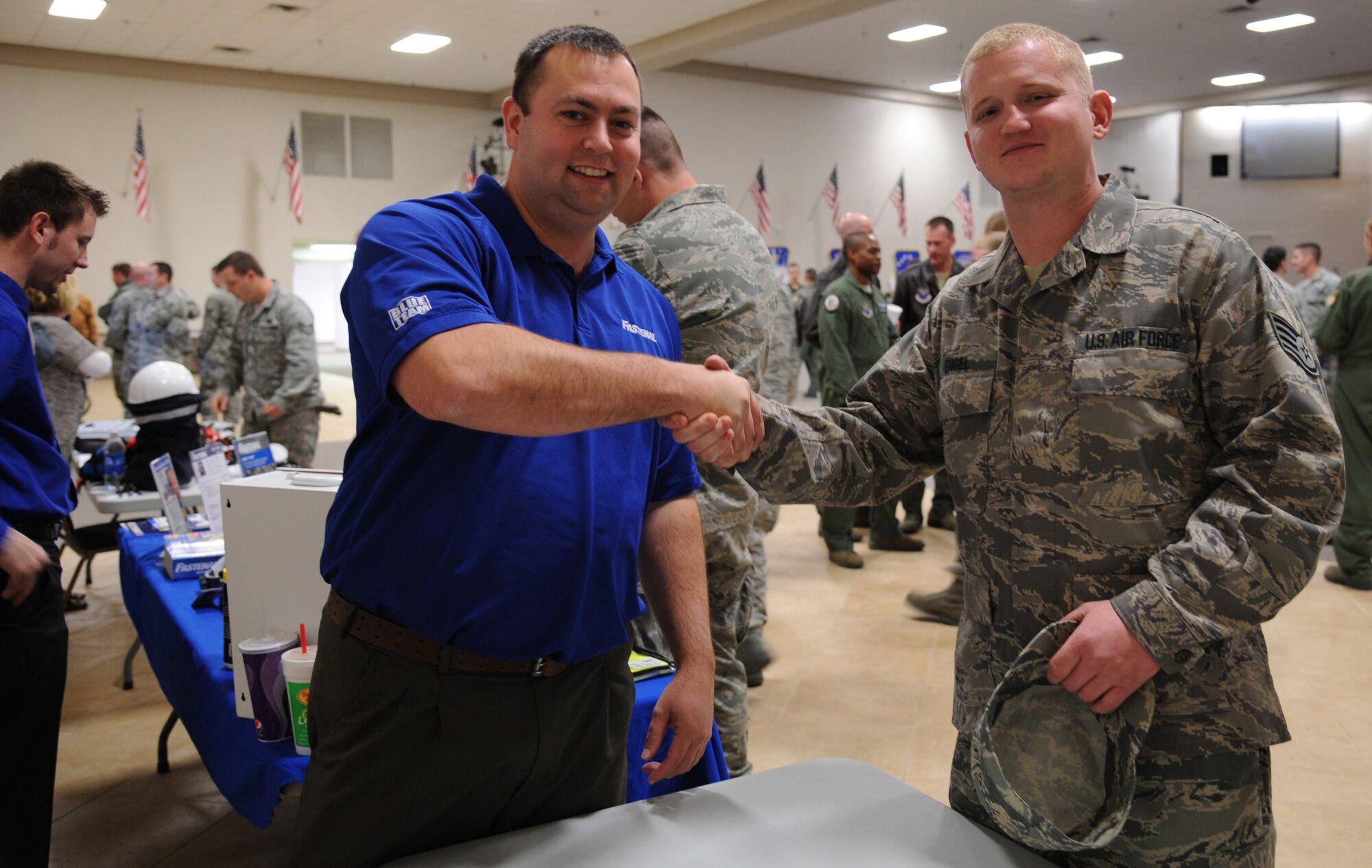 Chris White, an employe for Fastenal, shakes hands with Staff Sgt. Joshua Engel, 2nd Aerospace Maintennance, at a Safety Fair at Hoban Hall on Barksdale Air Force Base, La., Jan. 3. Fastenal has had a lasting relationship with the Air Force over its 45 year lifespan. (U.S. Air Force photo/Airman 1st Class Andrew Moua)(RELEASED)