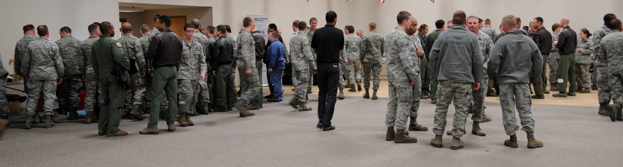 Airmen gather around display tables at a Safety Fair on Barksdale Air Force Base, La., Jan. 3. After the on-stage presentations by various companies, Airmen were free to look at the equipment on display. (U.S. Air Force photo/Airman 1st Class Andrew Moua)(RELEASED)