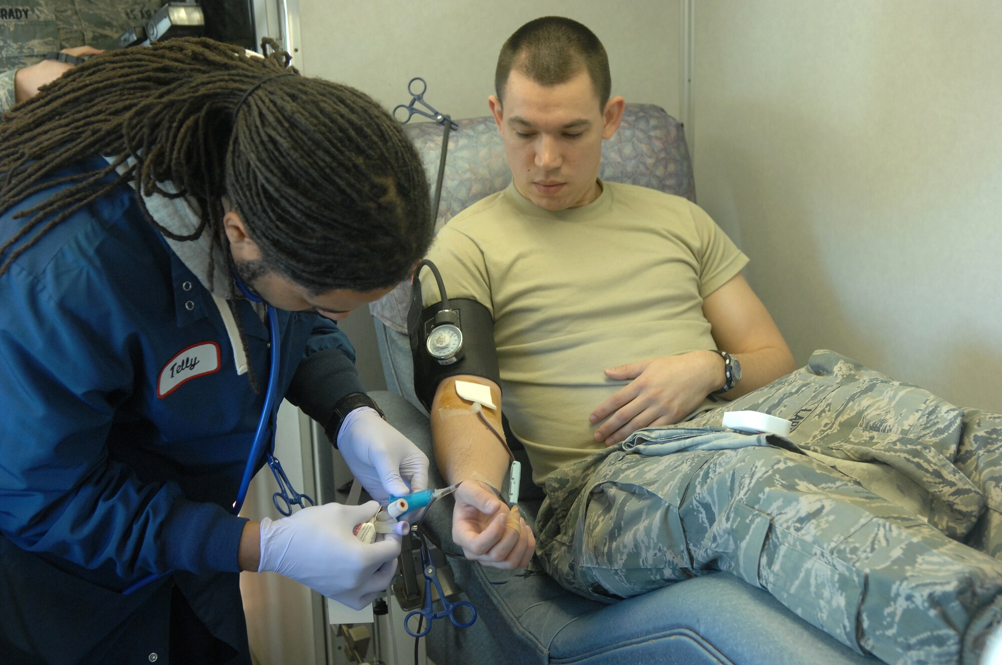 American Red Cross employee Telly Bostic finishes drawing blood from U.S. Air Force Staff Sgt. Joseph Lara, 20th Medical Operations Squadron mental health technician, at Shaw Air Force Base, S.C., Jan. 5, 2011. Shaw’s 20th Contracting Squadron and  20th Logistics Readiness Squadron directed and sponsored the event. (U.S. Air Force photo by Airman 1st Class Blake Hubbard/Released)