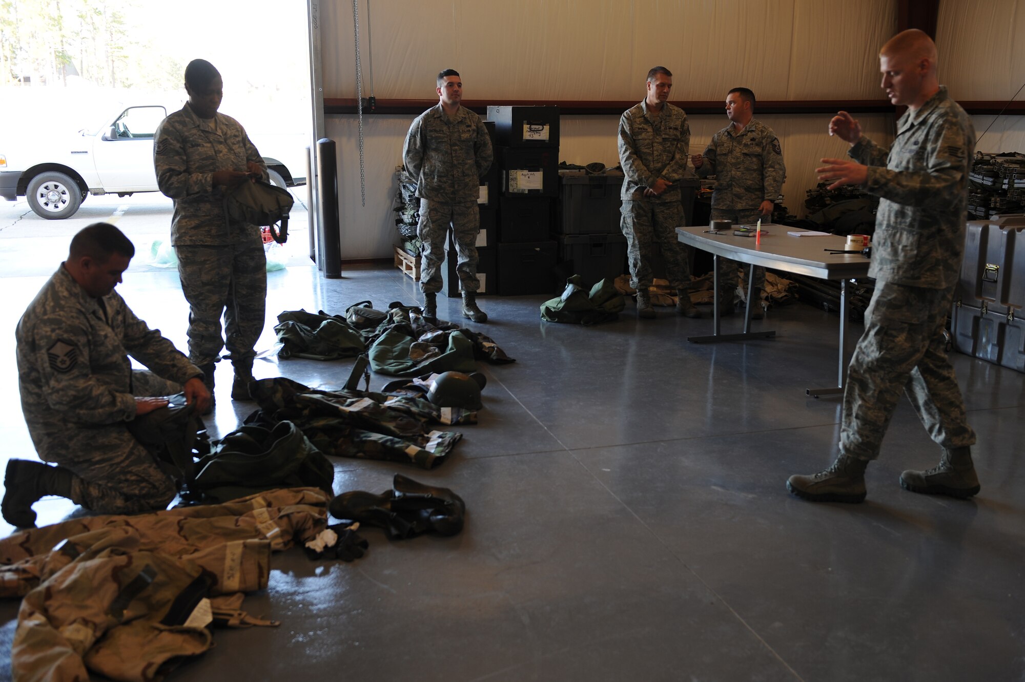 U.S. Air Force Airmen go through mobility bags during ability to survive and operate training at Moody Air Force Base, Ga., Jan. 5, 2012. ATSO is vital in preparing Airmen for hostile situations, teaching survival skills and how to correctly wear protective gear. (U.S. Air Force photo by Staff Sgt. Ciara Wymbs/Released)  