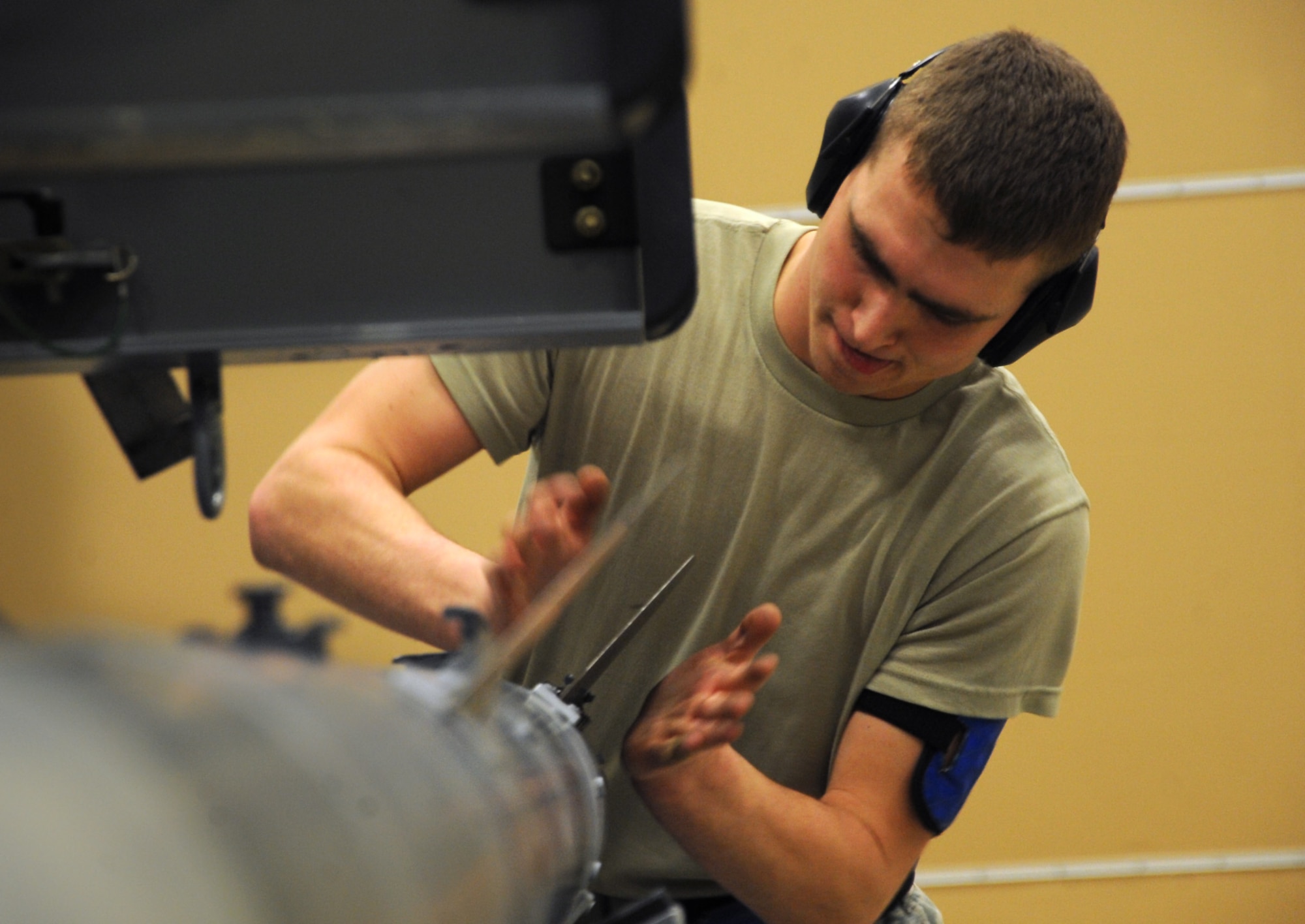 JOINT BASE ELMENDORF-RICHARDSON, Alaska --Senior Airman Damian Herbert secures a fin on an air intercept missile 9 during the weapons load crew of the year competition Dec. 14. Three teams competed for the annual award after winning a quarterly competition. Herbert is an aircraft armament systems specialist with the 525th Aircraft Maintenance Unit. (U.S. Air Force photo/Staff Sgt. Cynthia Spalding)