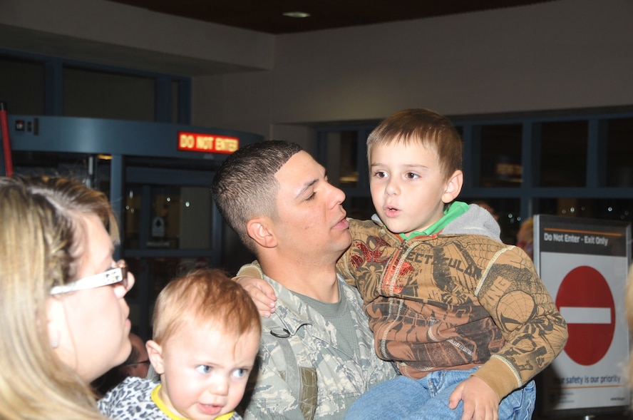 Staff Sgt. Paul Carson, 377 SFG, holds his 5 year-old son, Evan, after returning from deployment. U.S. Air Force Photo by Todd Berenger