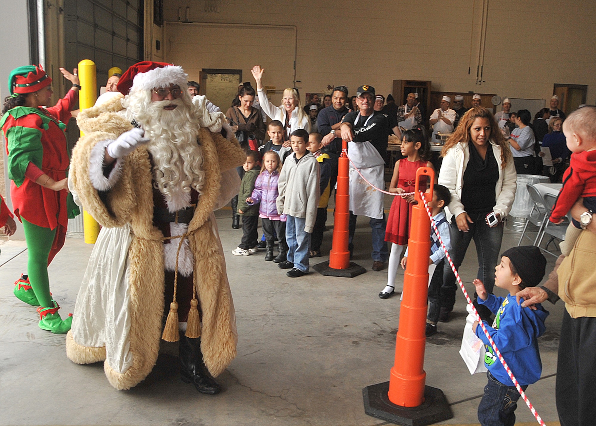 Santa Claus makes a grand entrance Dec. 20 at Fire Station No. 2 during “Operation Holiday Cheer” as families enjoy an afternoon of food and entertainment.  U.S. air Force Photo by Todd Berenger