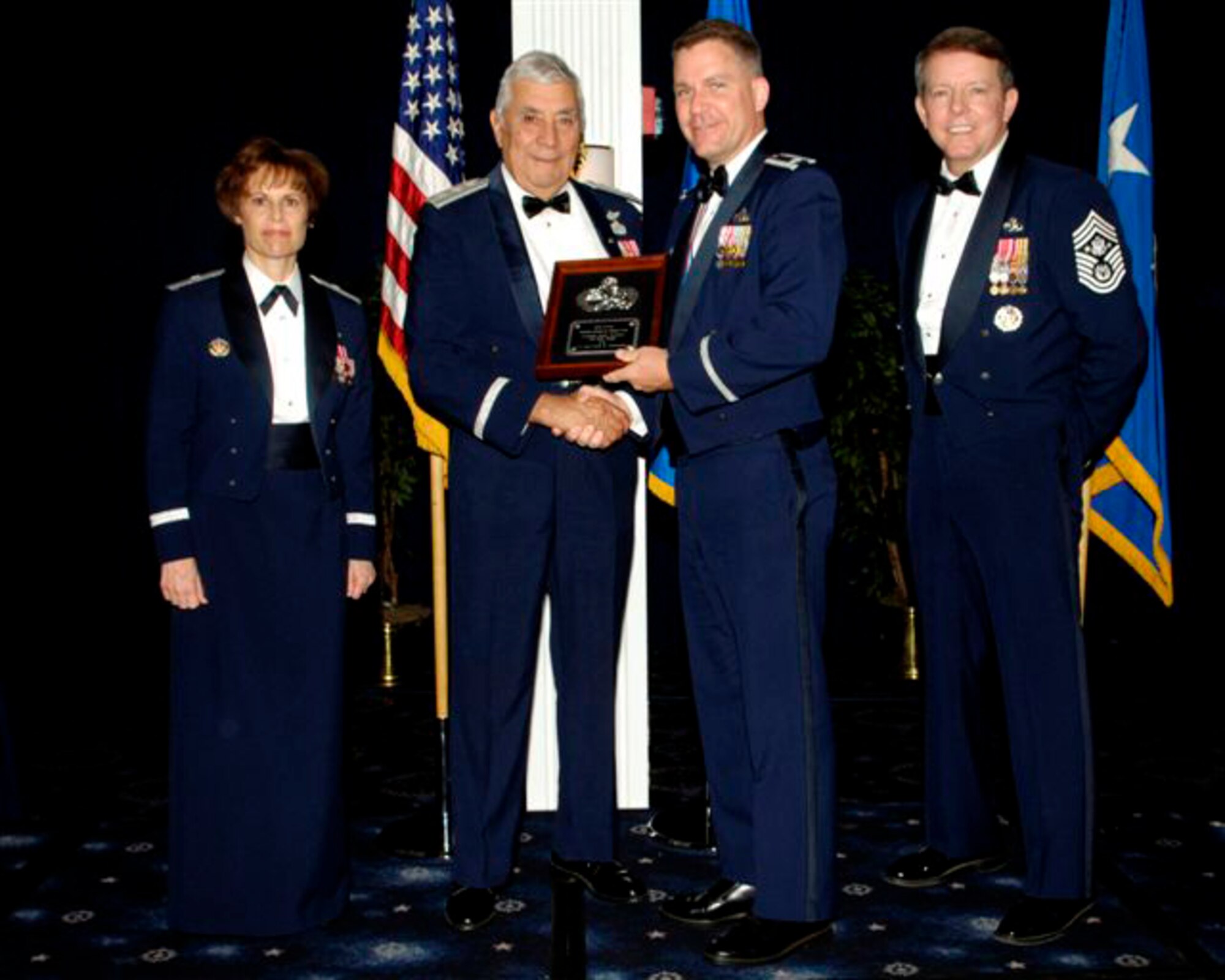 Brig. Gen. Kathleen Close, retired Lt. Gen. Leo Marquez, Lt. Col. Leif Johnson and Chief Master Sgt. of the Air Force Rodney McKinley gather in a ceremony on Bolling Air Force Base, Washington D.C., as Colonel Johnson is presented with the 2006 Lt. Gen. Leo Marquez Award by General Marquez