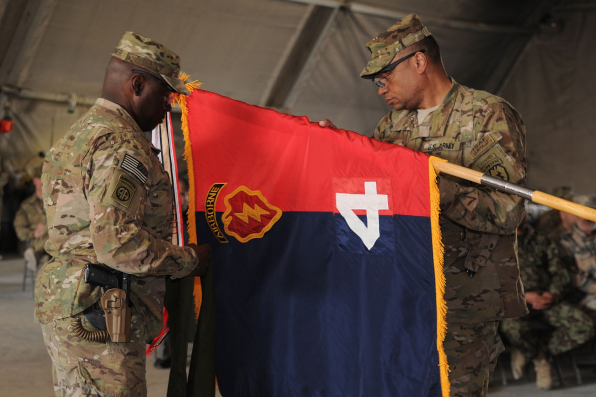Army Col. Morris Goins, 4th Brigade Combat Team (Airborne), 25th Infantry Division, Task Force Spartan commander and Command Sgt. Maj. Terry Gardner, command sergeant major of Task Force Spartan, uncase the unit’s colors Dec. 31 as the brigade
assumes responsibility from Task Force Duke. (U.S. Army photo/Staff Sgt. Jason Epperson)