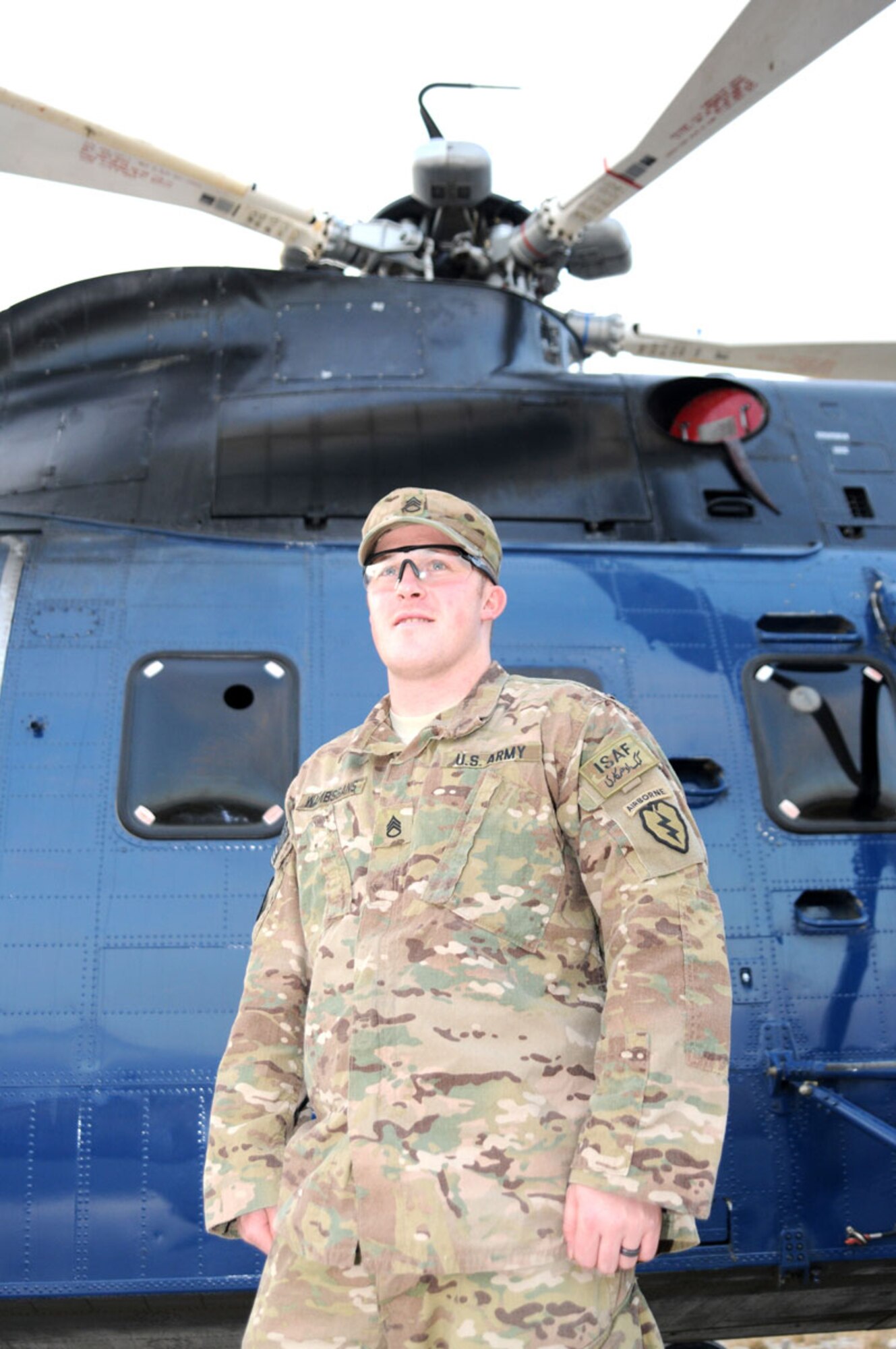 Army Staff Sgt. Michael Wambsgans, support operations noncommissioned officer in charge with TF Centurion stands in front of a Sikorsky S-61 helicopter at Forward Operating Base Salerno Tuesday. (U.S. Army photo/Staff Sgt. Jason Epperson)