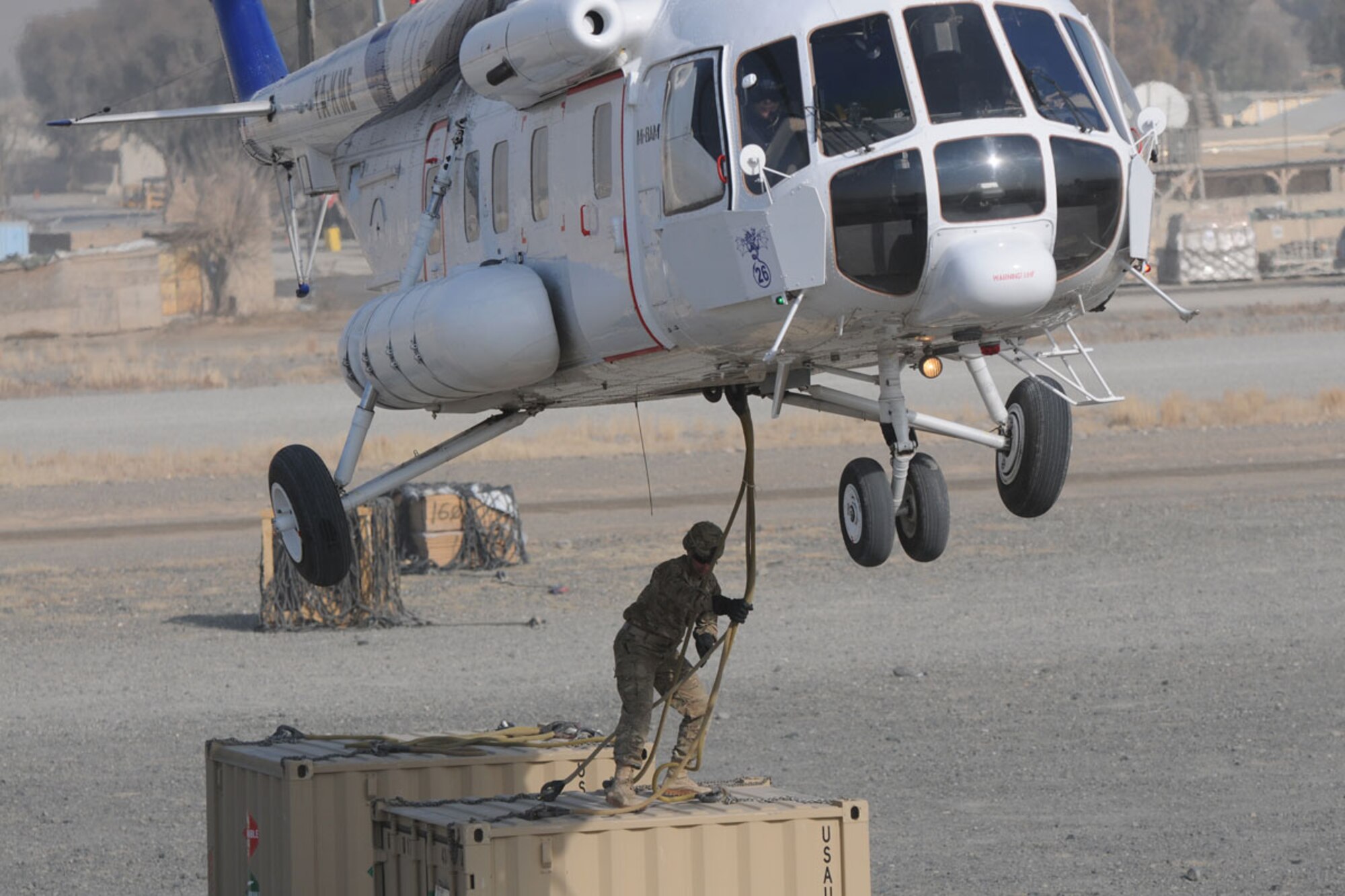 San Antonio native Sgt. Joshua Stevens, a parachute rigger with TF Centurion, prepares to hook up a sling load to a Russian Mi-8 Hip helicopter at FOB Salerno Tuesday. (U.S. Army photo/Staff Sgt. Jason Epperson)