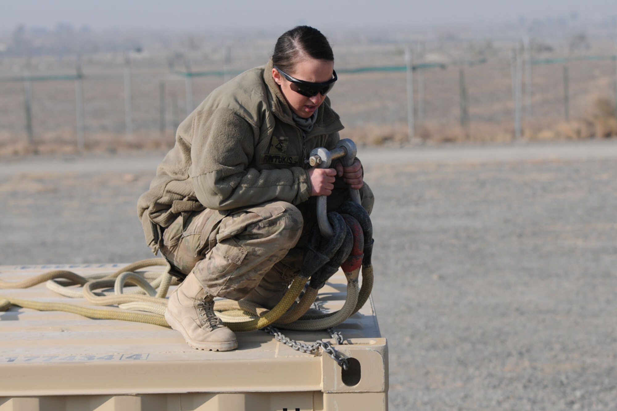 Pfc. Briana Funtukis, a parachute rigger with Headquarters and Headquarters Company, 725th Brigade Support Battalion (Airborne), Task Force Centurion, prepares a sling load to be airlifted at Forward Operating Base Salerno Tuesday. Funtukis, a native of Detroit, is part of Task Force Spartan, which recently took over areas of responsibility in Paktya and Khowst provinces. (U.S. Army photo/Staff Sgt. Jason Epperson)