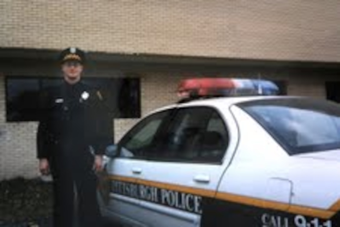 Airman 1st Class Kevin Carey stands by his City of Pittsburg (Pa.) patrol car in this undated photo.  Airmen Carey joined the Air National Guard in 2011 at age 39 after spending 18 years as a civilian police officer. (U.S. Air Force photo/Dan Hawkins)