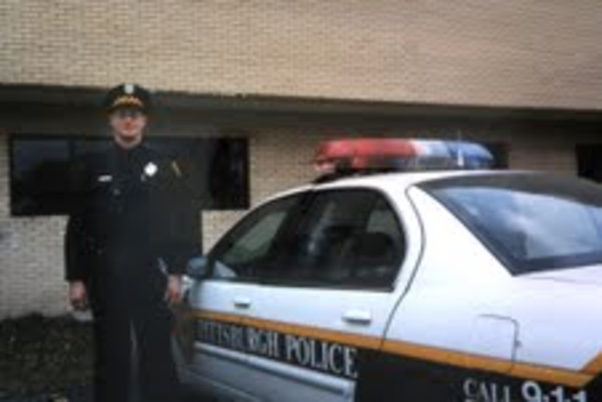 Airman 1st Class Kevin Carey stands by his City of Pittsburg (Pa.) patrol car in this undated photo.  Airmen Carey joined the Air National Guard in 2011 at age 39 after spending 18 years as a civilian police officer. (U.S. Air Force photo/Dan Hawkins)