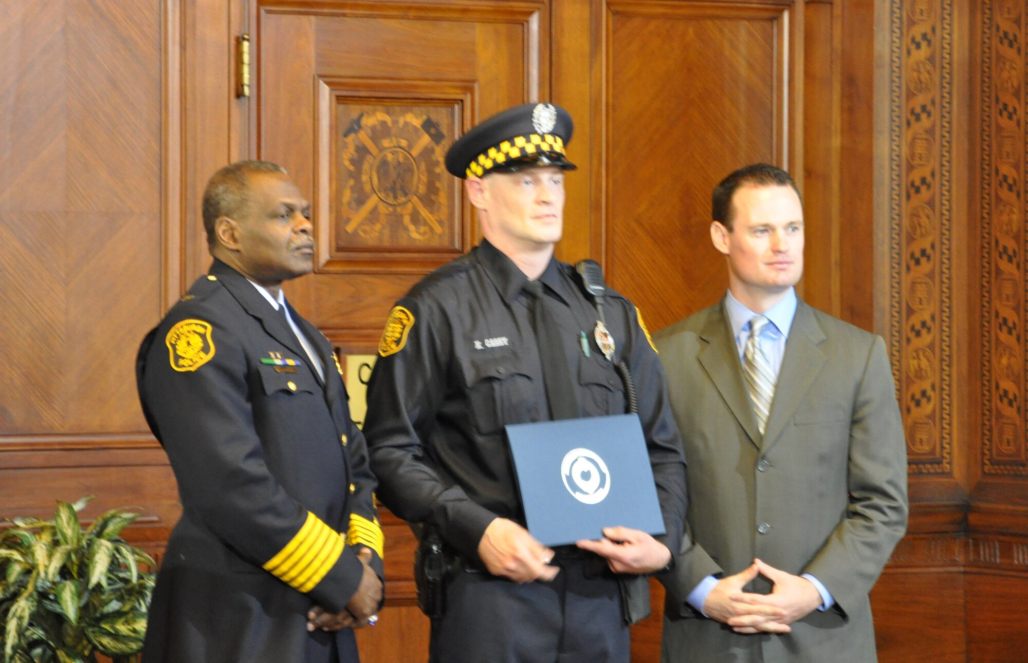 Airman 1st Class Kevin Carey receives a City of Pittsburgh (Pa.) proclamation from the mayor after saving four people from an apartment fire while working as a police officer in this undated photo.  Airmen Carey joined the Air National Guard in 2011 at age 39 after spending 18 years as a civilian police officer. (U.S. Air Force photo/Dan Hawkins)