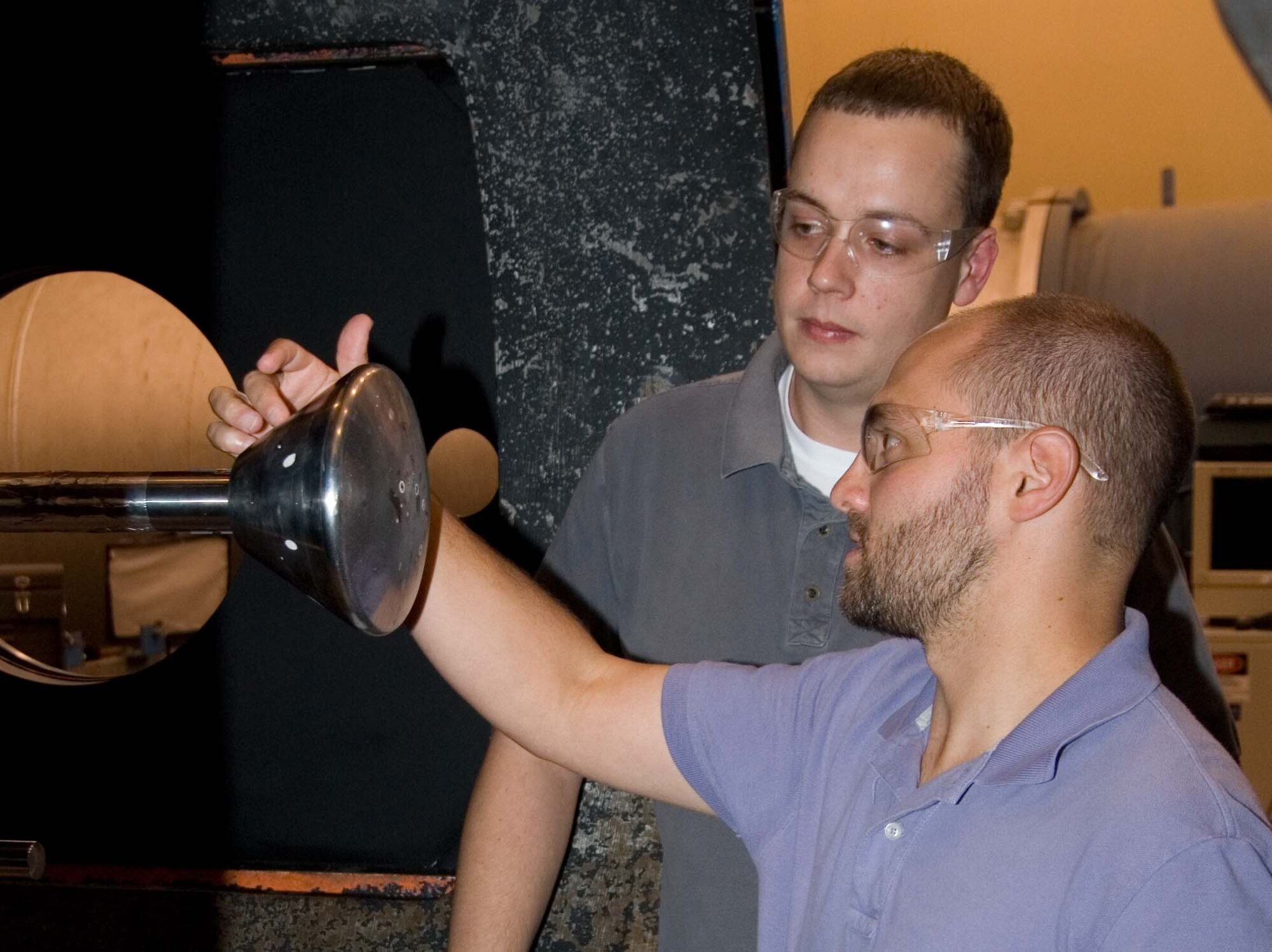 From left, Tunnel 9 ATA Project Engineer Dan Lewis and NASA's principal investigator for the project and NASA’s Orion acting aerothermal lead and system manager Adam Amar review the Orion capsule test article before the Tunnel 9 facility is secured for a test. (Photo provided)