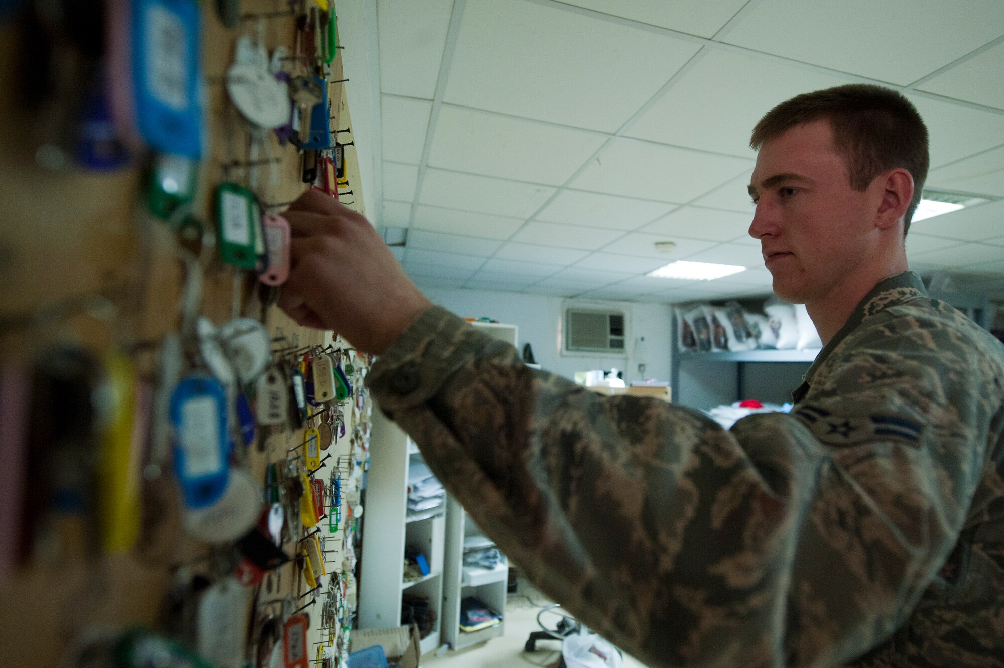 Airman 1st Class David Nearbin, 332nd Expeditionary Force Support Squadron lodging flight, pulls a set of keys for in-bound personnel Jan. 6, 2012 at an undisclosed location in Southwest Asia. Nearbin and fellow lodging flight members are in charge of keeping 100 percent accountability for every key they issue. Nearbin is deployed from Little Rock Air Force Base, Ark. (U.S. Air Force photo by Staff Sgt. Joshua J. Garcia)