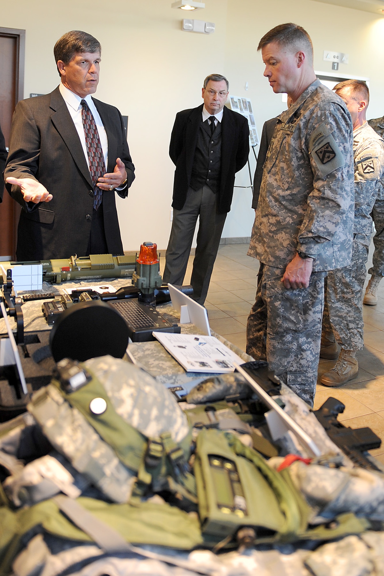 Jim Buchwald, Army Training Support Center  Life Training Systems, chief briefs U.S. Army Lt. Gen David Perkins, the new Combined Arms Center commander during his visit to the Army Training Support Center ATSC at Fort Eustis. Jan. 4. Perkins spent the day in various briefings, reviewed a product display, and toured ATSC's buildings. (U.S. Air Force photo by Staff Sgt. Antoinette Gibson/Released)