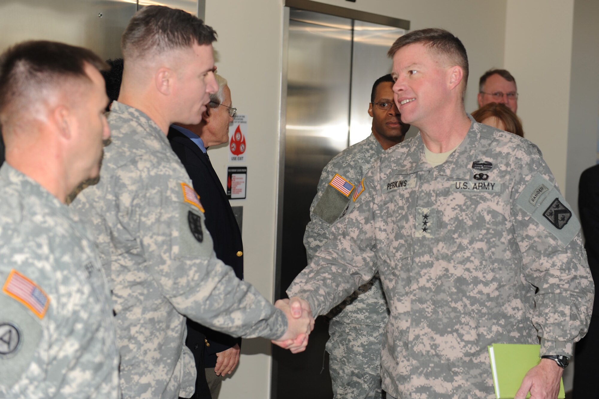 U.S. Army Lt. Gen. David Perkins, the new Combined Arms Center commander, meets Col. Edward McGinley, System Training Integration and Devices Division, division chief during a his visit to the Army Training Support Center  at Fort Eustis  Jan 4.  Lt. Gen. Perkins assumed command Nov. 22, 2011. The liuetenant general replaced Lt. Gen. Robert Caslen Jr., who is now the commander of the NATO training mission in Iraq and chief of the Office of Security Cooperation in Iraq. (U.S. Air Force photo by Staff Sgt. Antoinette Gibson/Released)