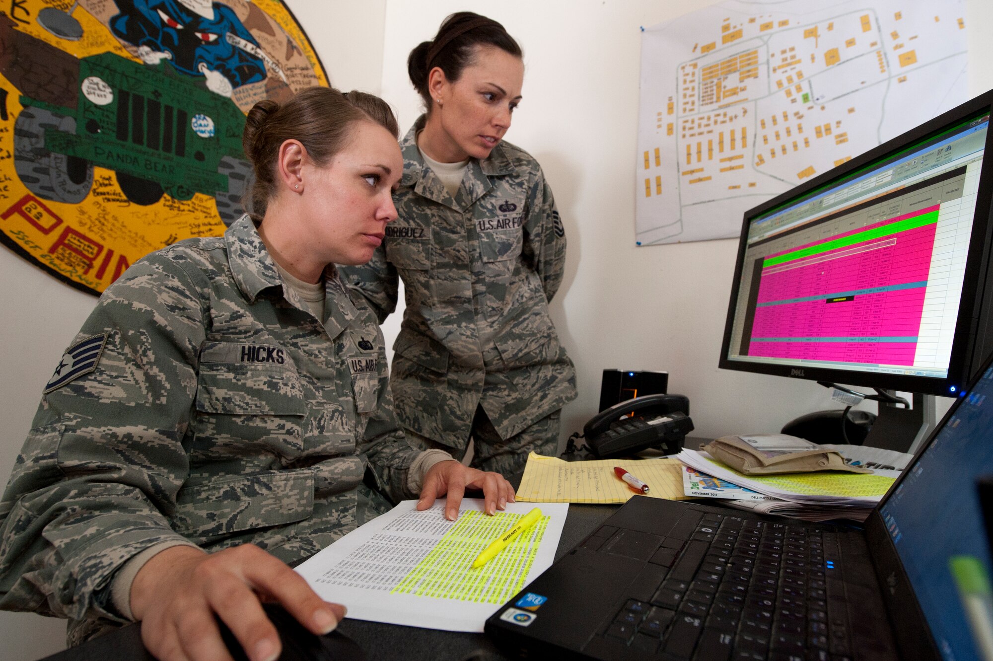 Master Sgt. Stacy Rodriguez, 332nd Expeditionary Force Support Squadron lodging flight, goes over an accountability listing with Staff Sgt. Emma Hicks, also in the lodging flight for the 332nd EFSS, Jan. 6, 2012 at an undisclosed location in Southwest Asia. The lodging flight performs weekly accountability checks alongside Personnel Support for Contingency Operations, to ensure 100 percent accountability of assigned personnel, in case of a red cross notification. Rodriguez is deployed from Davis-Monthan Air Force Base, Ariz., and Hicks is deployed from Spangdahlem Air Base, Germany. (U.S. Air Force photo by Staff Sgt. Joshua J. Garcia/Released)