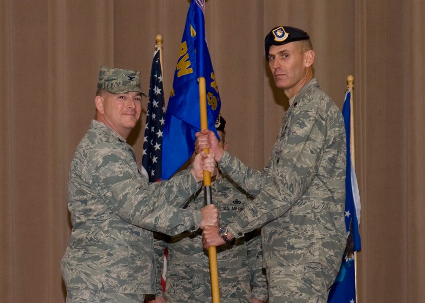 Col. Scott Hoover, 2nd Mission Support Group commander, passes the 2nd Security Forces Squadron guidon to Maj. Mark Breed, 2 SFS commander, during a change-of-command ceremony at Hoban Hall on Barksdale Air Force Base, La., Jan. 5. The passing of the guidon signifies the responsibilities of an organization being transferred over to the new commander. (U.S. Air Force photo/Airman 1st Class Benjamin Gonsier)(RELEASED) 